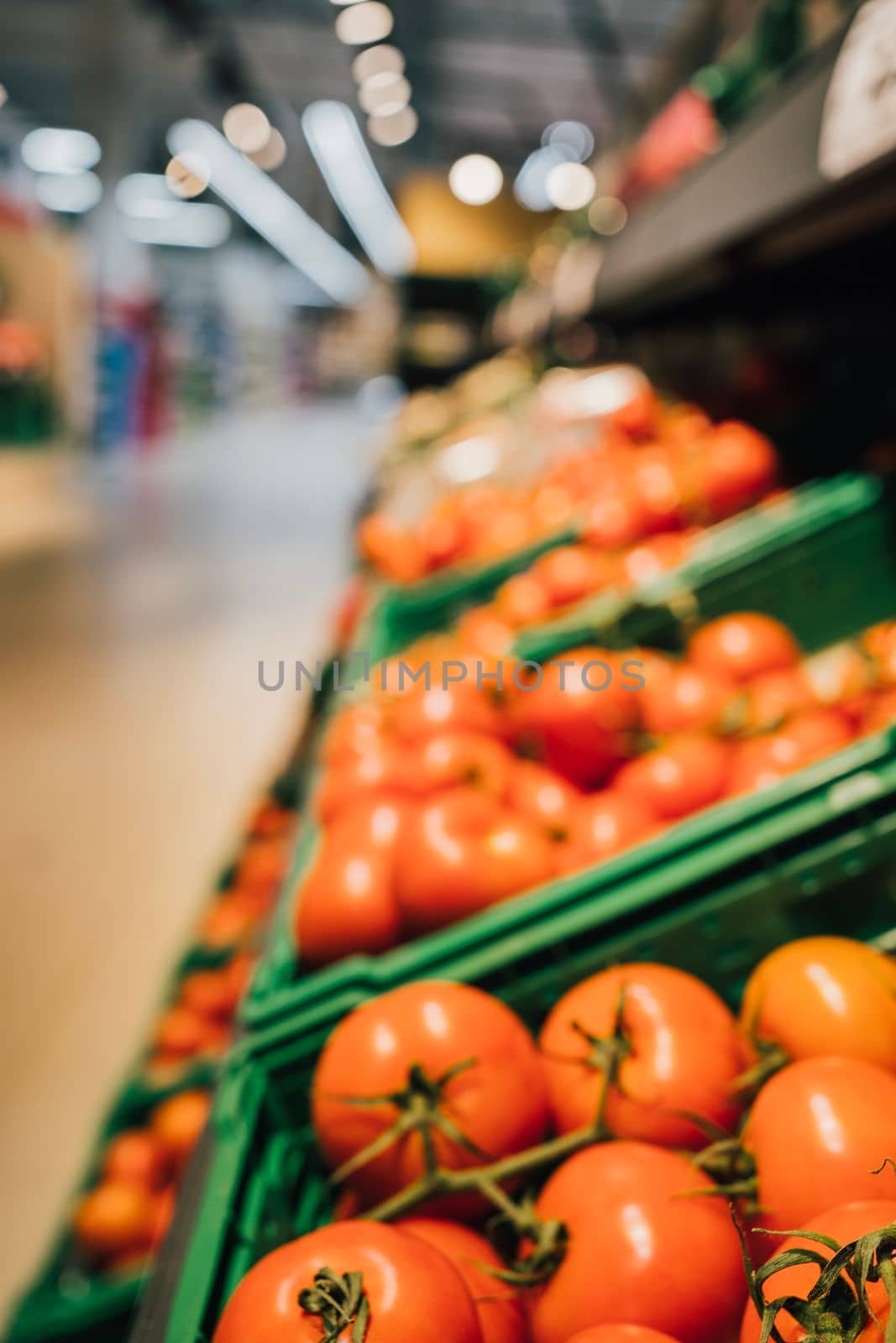 Fresh red tomatoes in boxes. Vegetables on supermarket shelves for sale. Natural food. Healthy eating. Shop. Retail industry. Grocery shopping. Greengrocers. Mart.