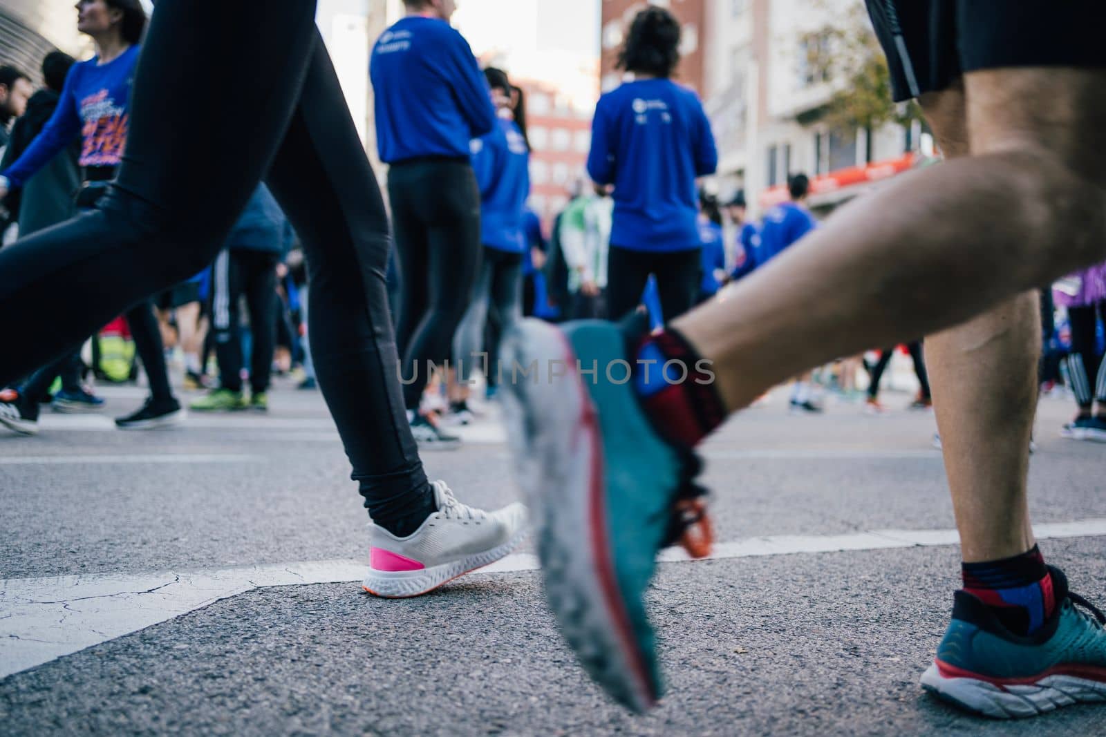 Group of unidentified marathon racers warming up for run. low angle view.