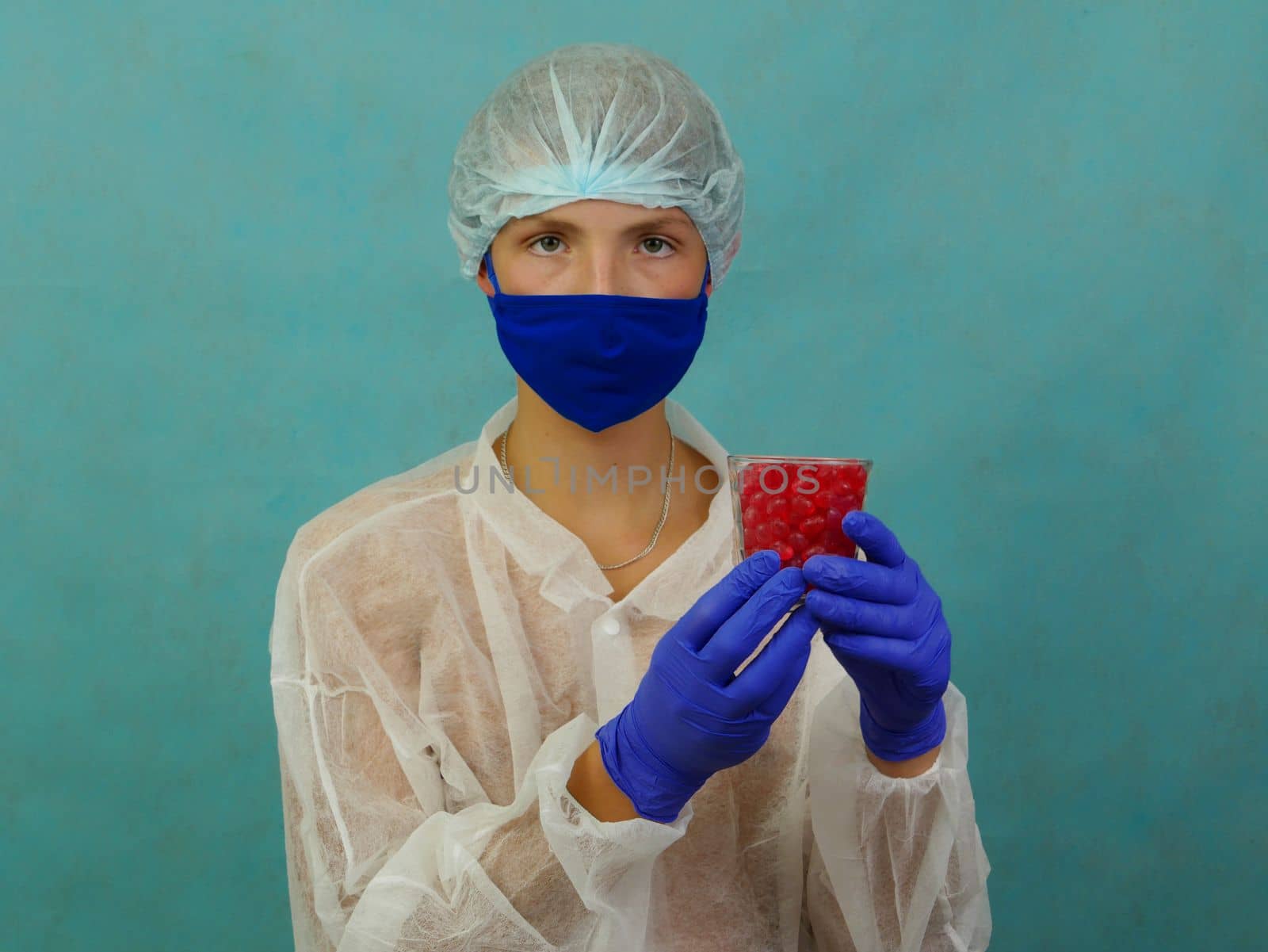 A guy in a robe, mask, gloves holds a glass of pills. by gelog67