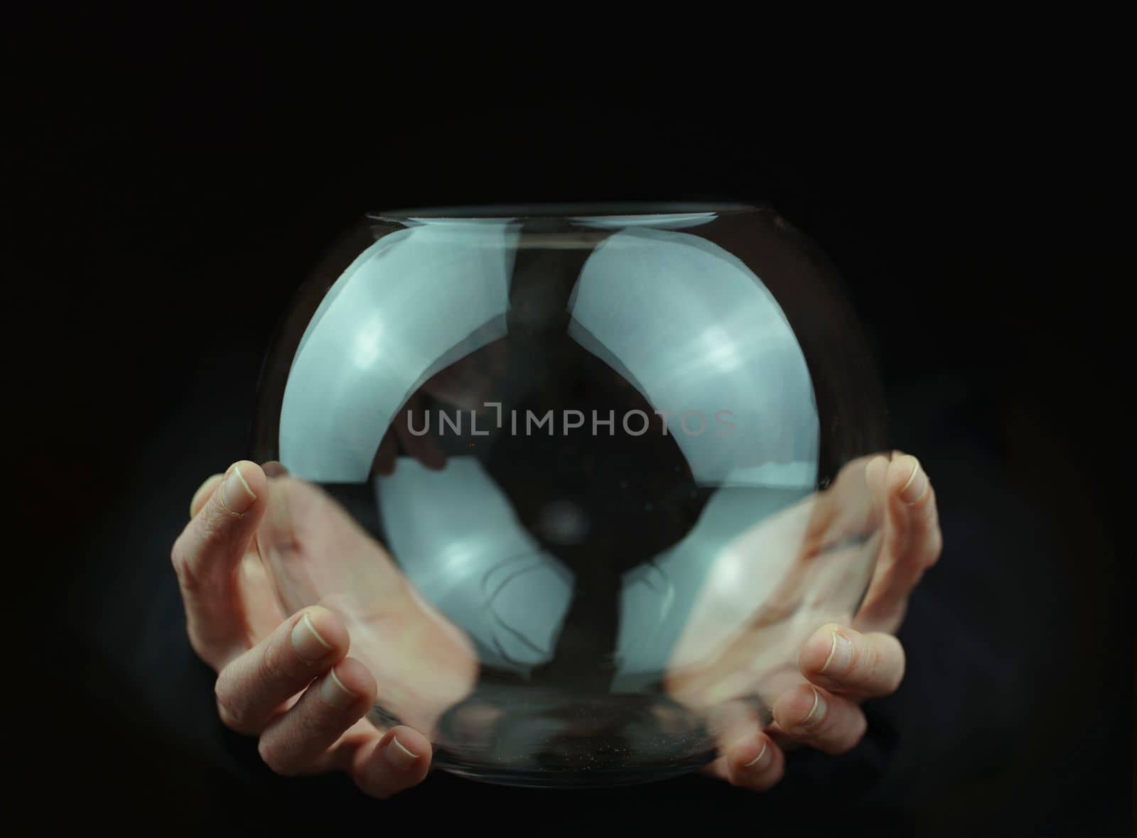 transparent glass ball in hands by Costin