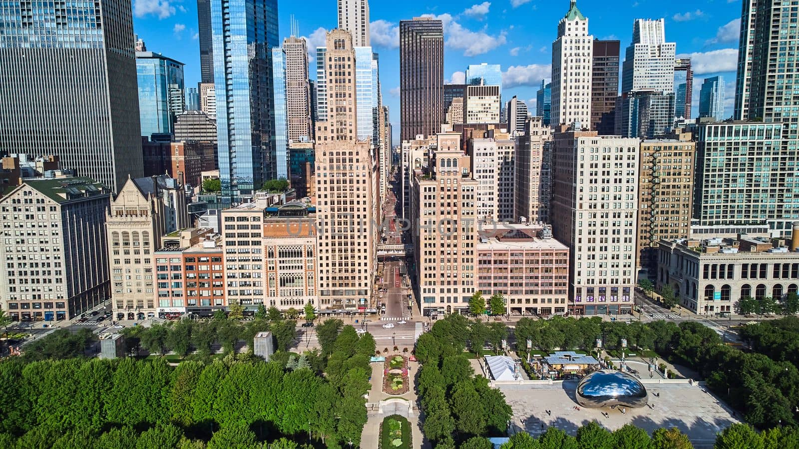 Image of Millennium Park by row of skyscrapers next to Cloud Gate The Bean