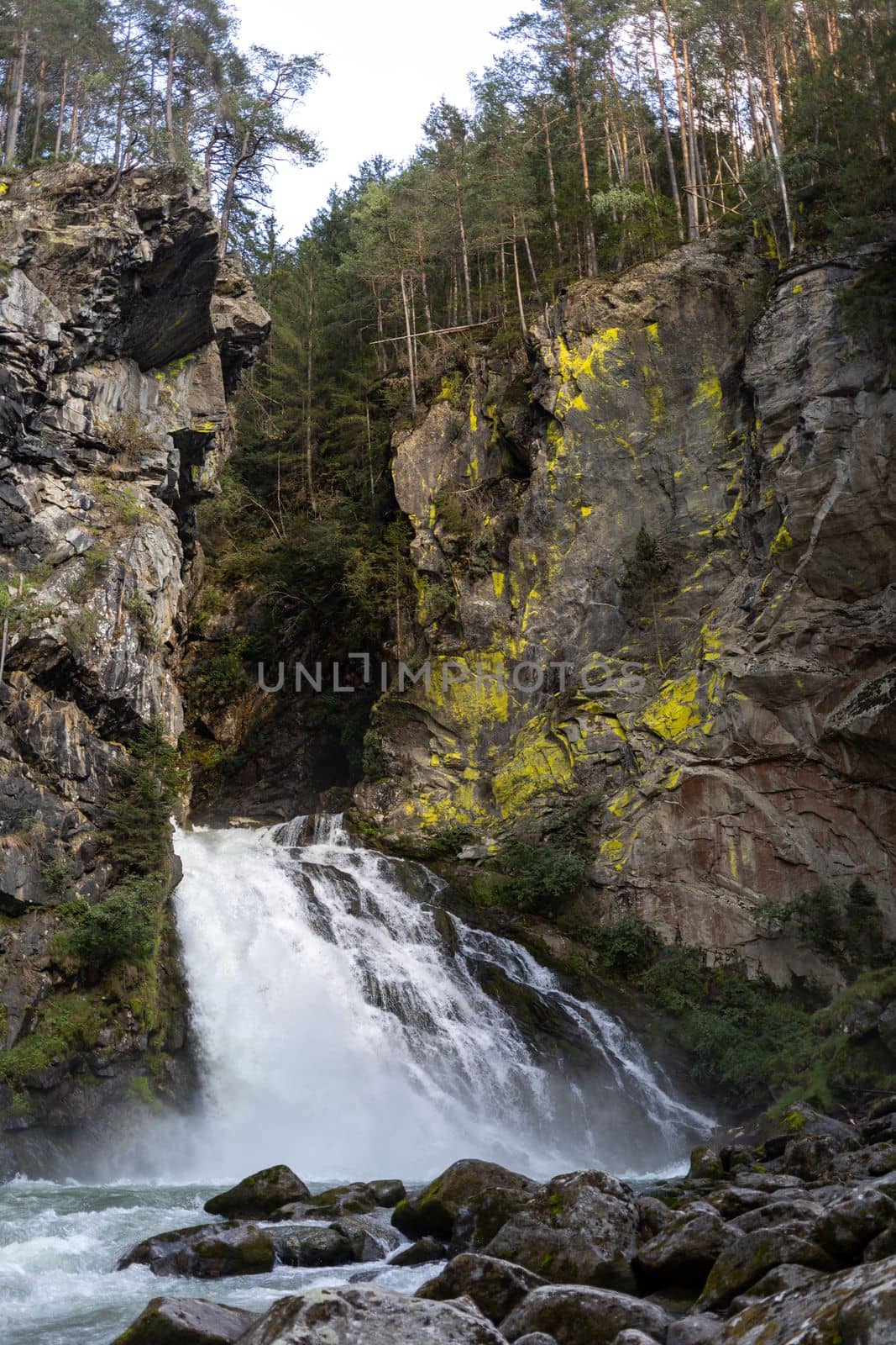 waterfall between old rocks beautiful nature background by Chechotkin