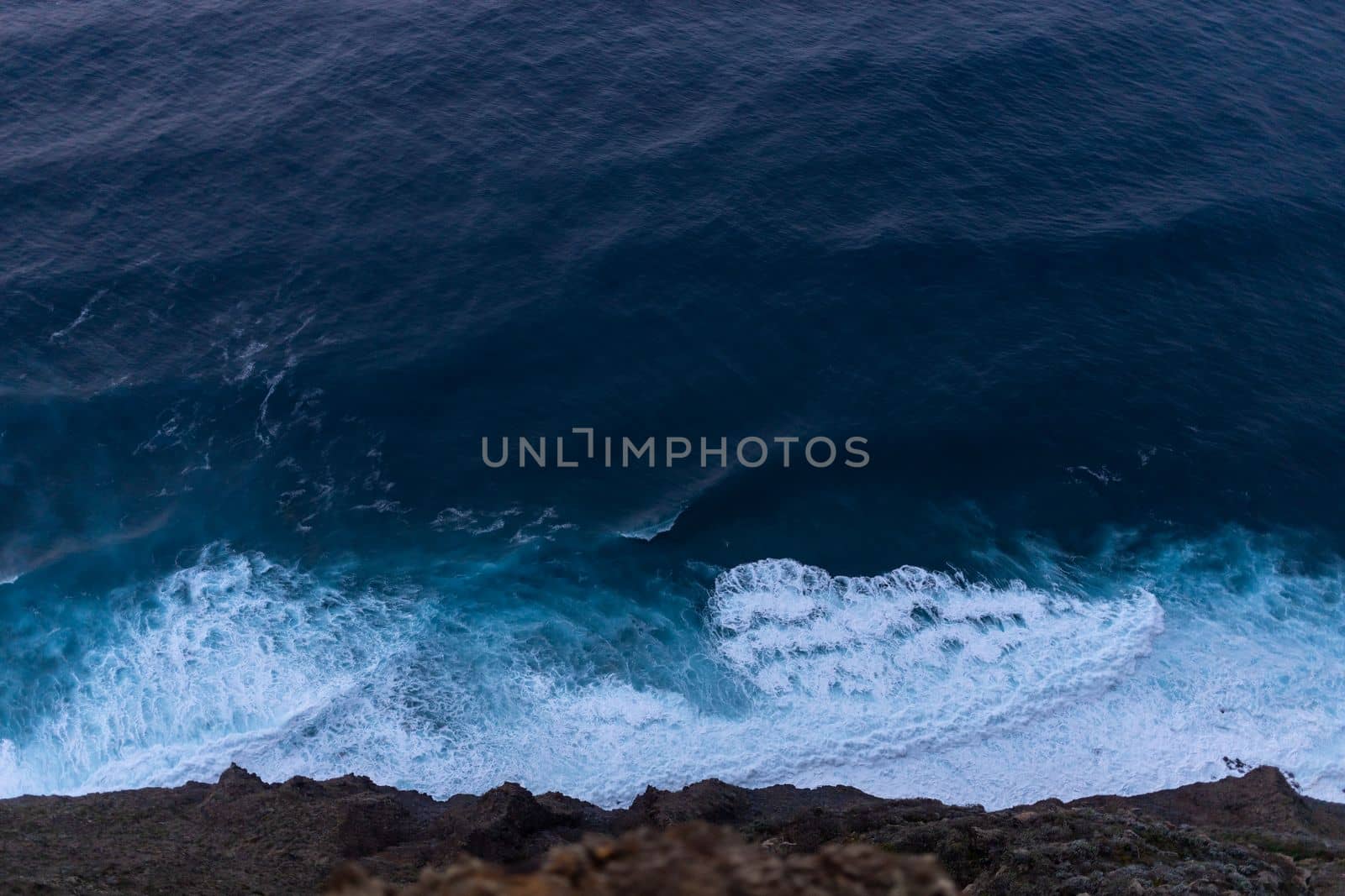 ocean surf waves at sunset view from above by Chechotkin