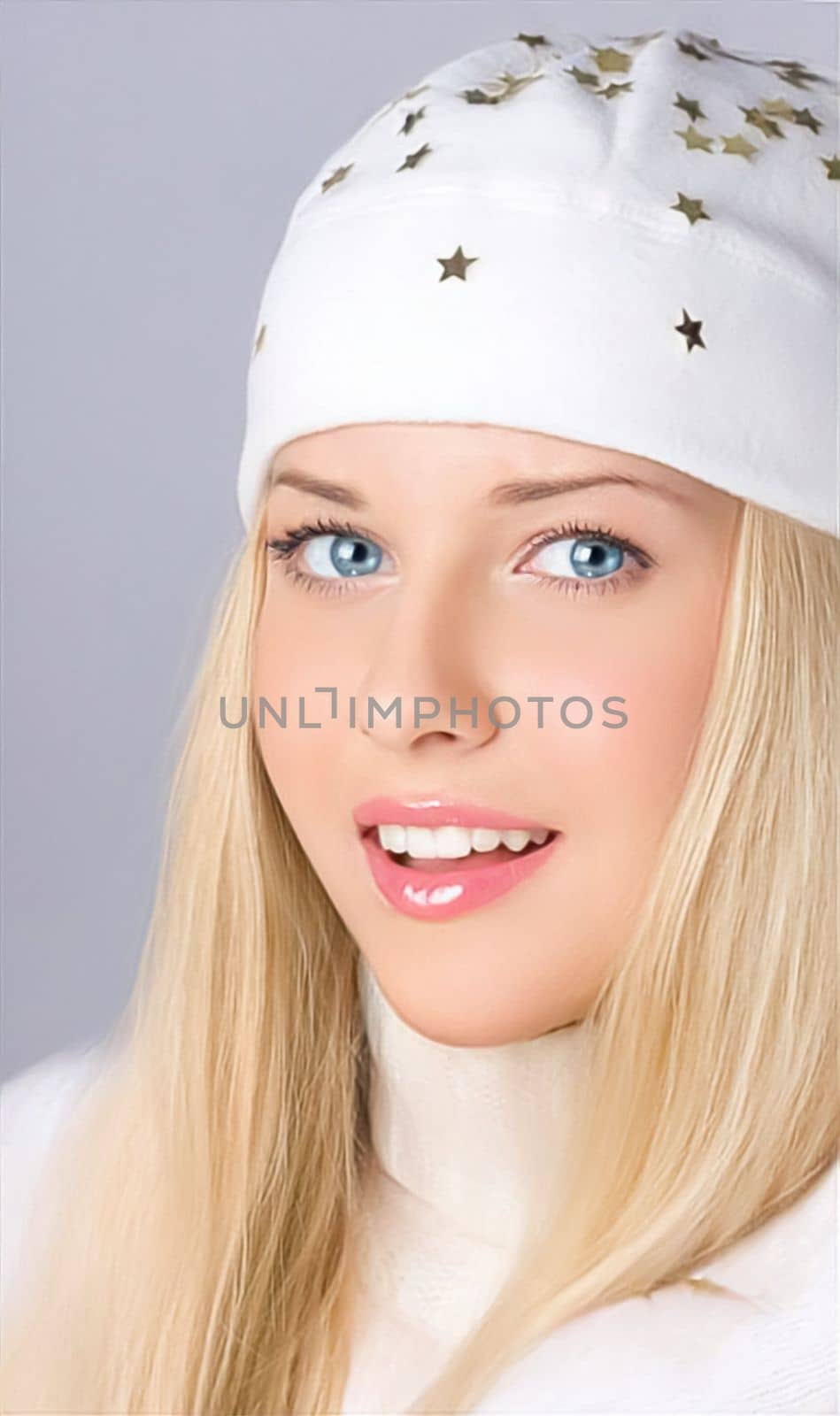 Happy holidays, Merry Christmas, and a lady wearing a white benny hat, joy, beauty, and elegance. Portrait of a beautiful blonde girl who is smiling and having fun during the winter holidays, Christmas and New Year.