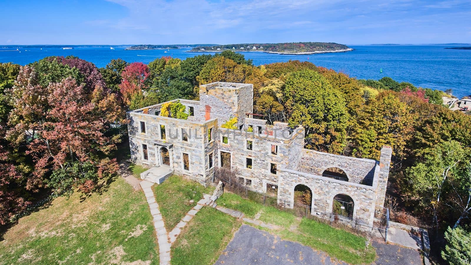 Image of Aerial over old abandoned stone structure in great condition with Maine ocean in background