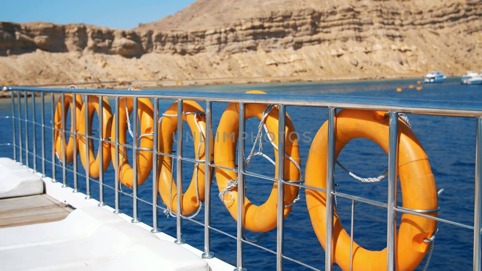 summer, sea, orange lifebuoy, hanging aboard a ferry, ship. special rescue equipment of the ship. saves the life of a person who is drowning. High quality photo