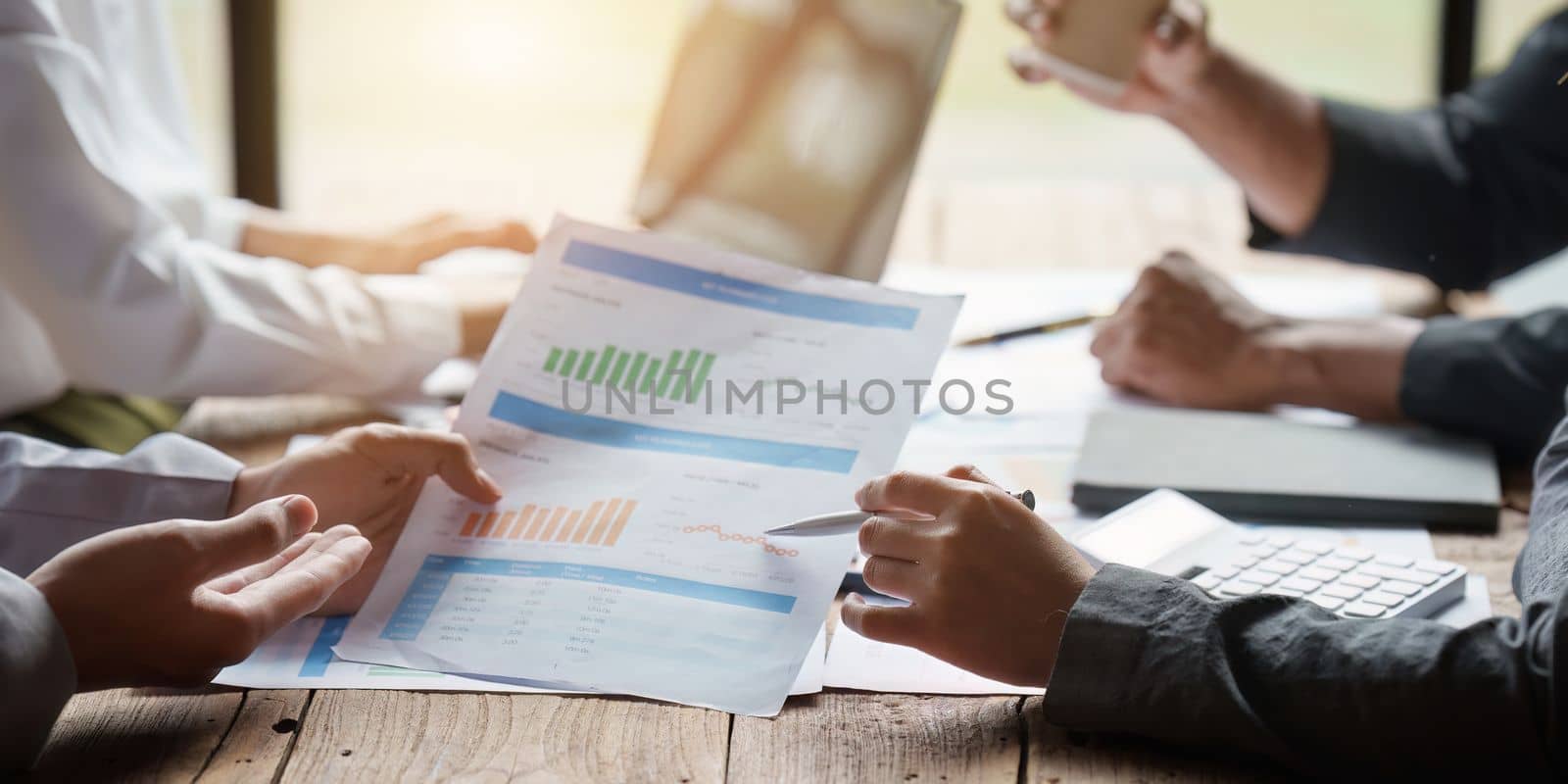 Group of Business people meeting for analysis data figures to plan business strategies. Business discussing, finance concept by itchaznong