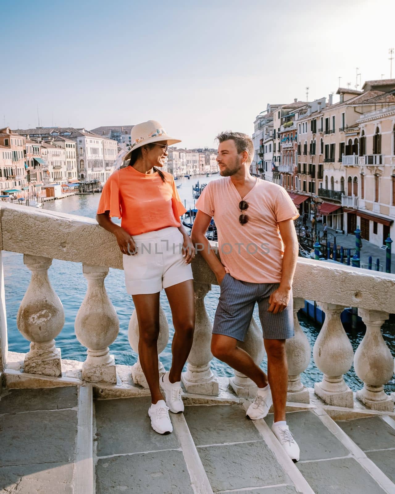 couple men and woman on a city trip to Venice Italy, colorful streets with canals Venice. Europe during summer
