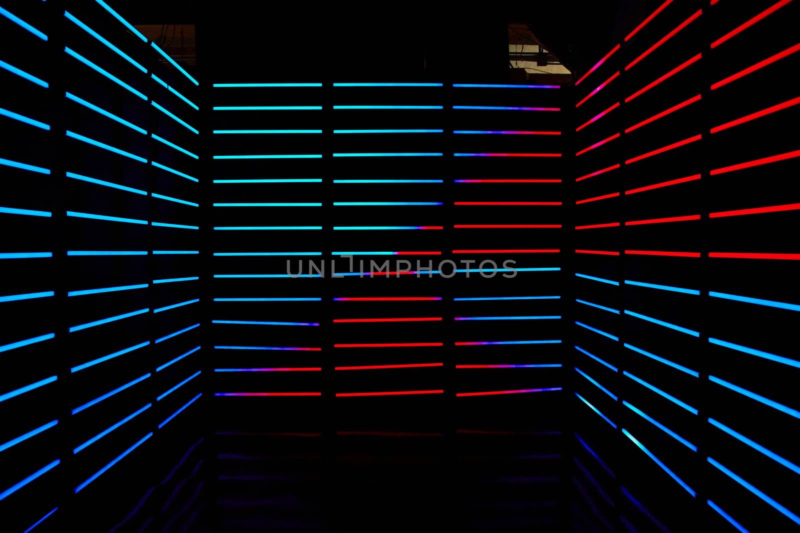 Empty dark room lined with red and blue LED horizontal poles of light by njproductions