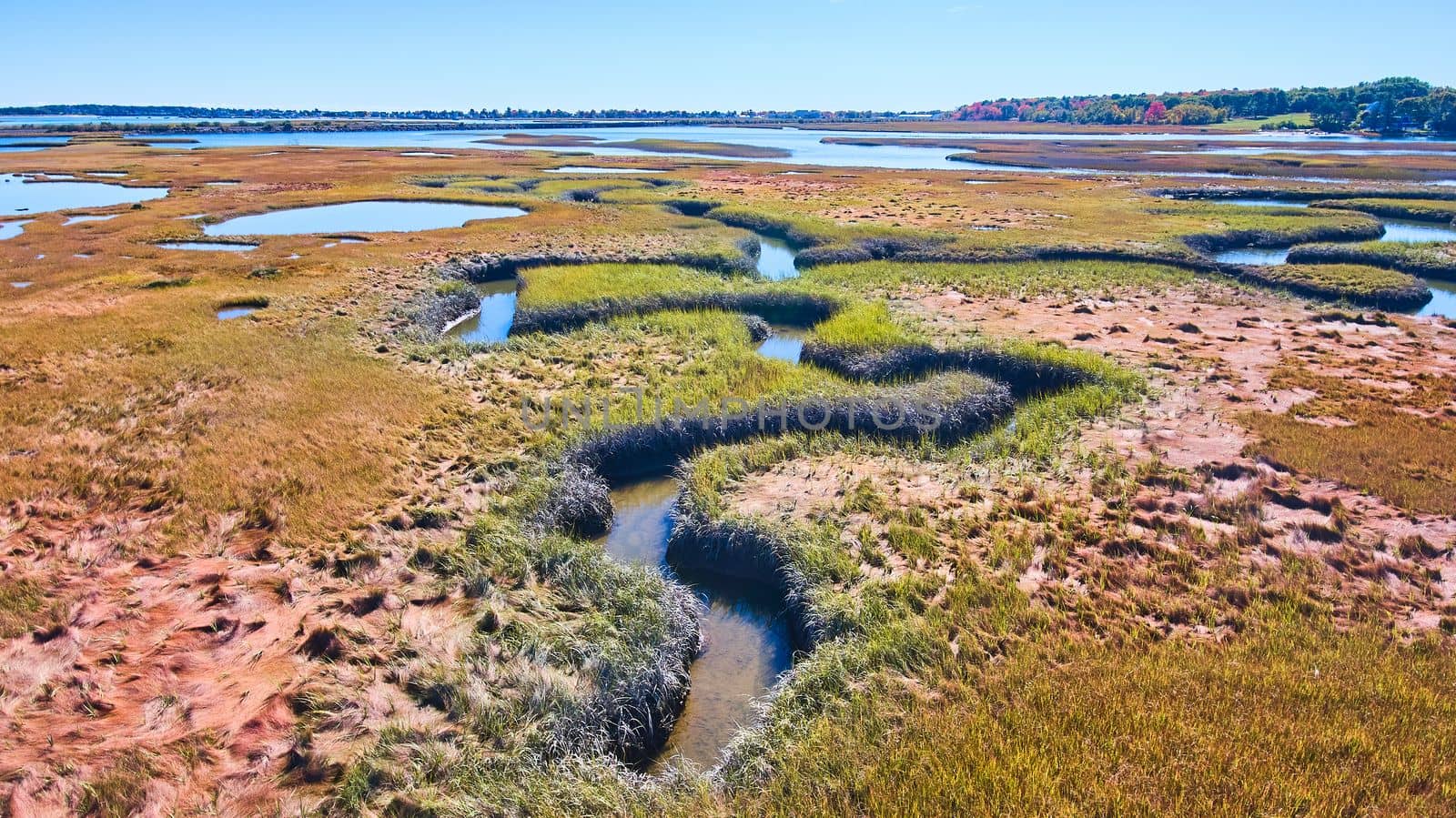 Winding creek zigs and zags through marshes of Maine by njproductions