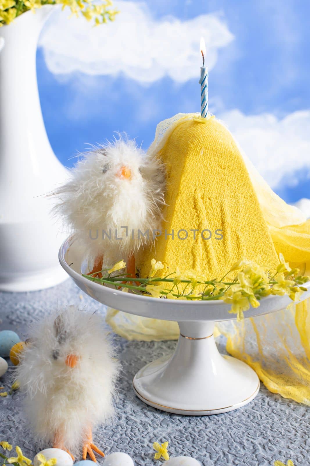 Traditional Easter Orthodox curd cake with yellow flowers against a blue sky with white clouds, High quality photo