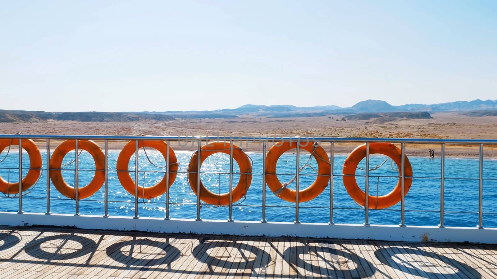 summer, sea, flight of a video camera along the deck of the ferry, ship, on board hangs many orange lifebuoys. High quality photo