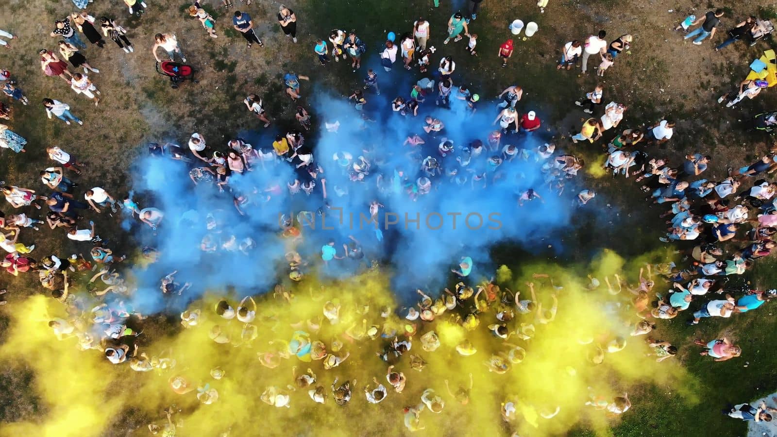 CHERKASY, UKRAINE - AUGUST 24, 2018 : aerial video with drone, Independence Day celebration, festival of colors, people throw up yellow and blue paints in sky, national flag by djtreneryay