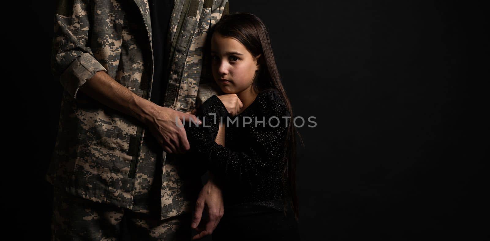 Masculine sad military man hugging her upset daughter indoors.