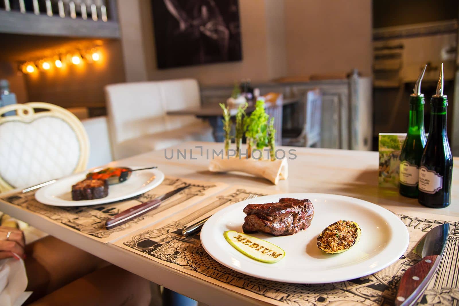 Beef steak with grilled vegetables served on white plate