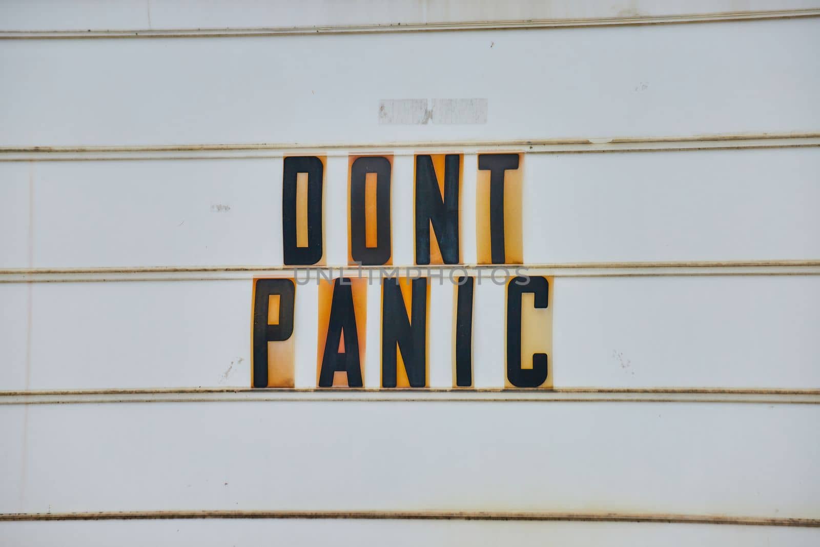 Detail of road sign all white with black capital letters DONT PANIC from Hitchhikers Guide to the Galaxy by njproductions
