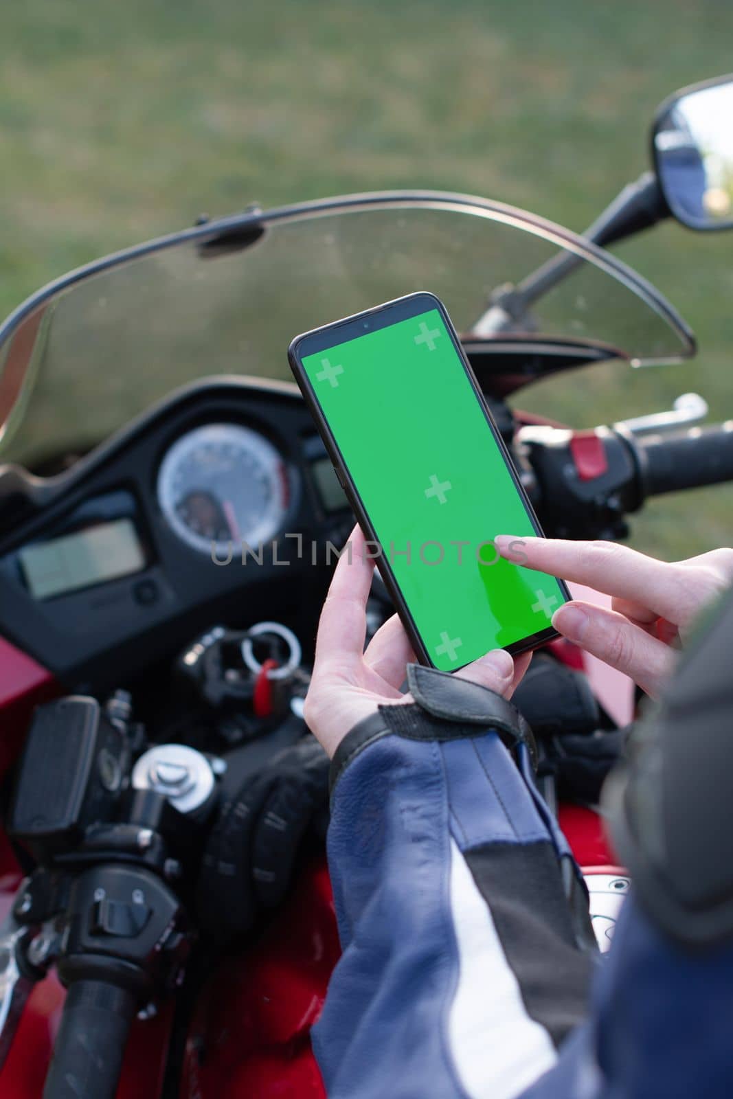 biker girl on a motorcycle enjoys a navigator in a mobile phone, a reflection in the rearview mirror, High quality photo