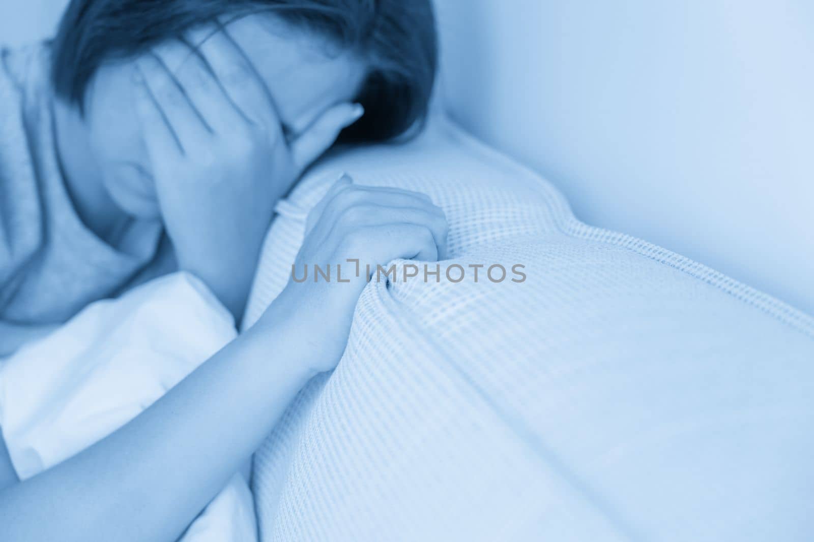 sad woman sitting on the bed