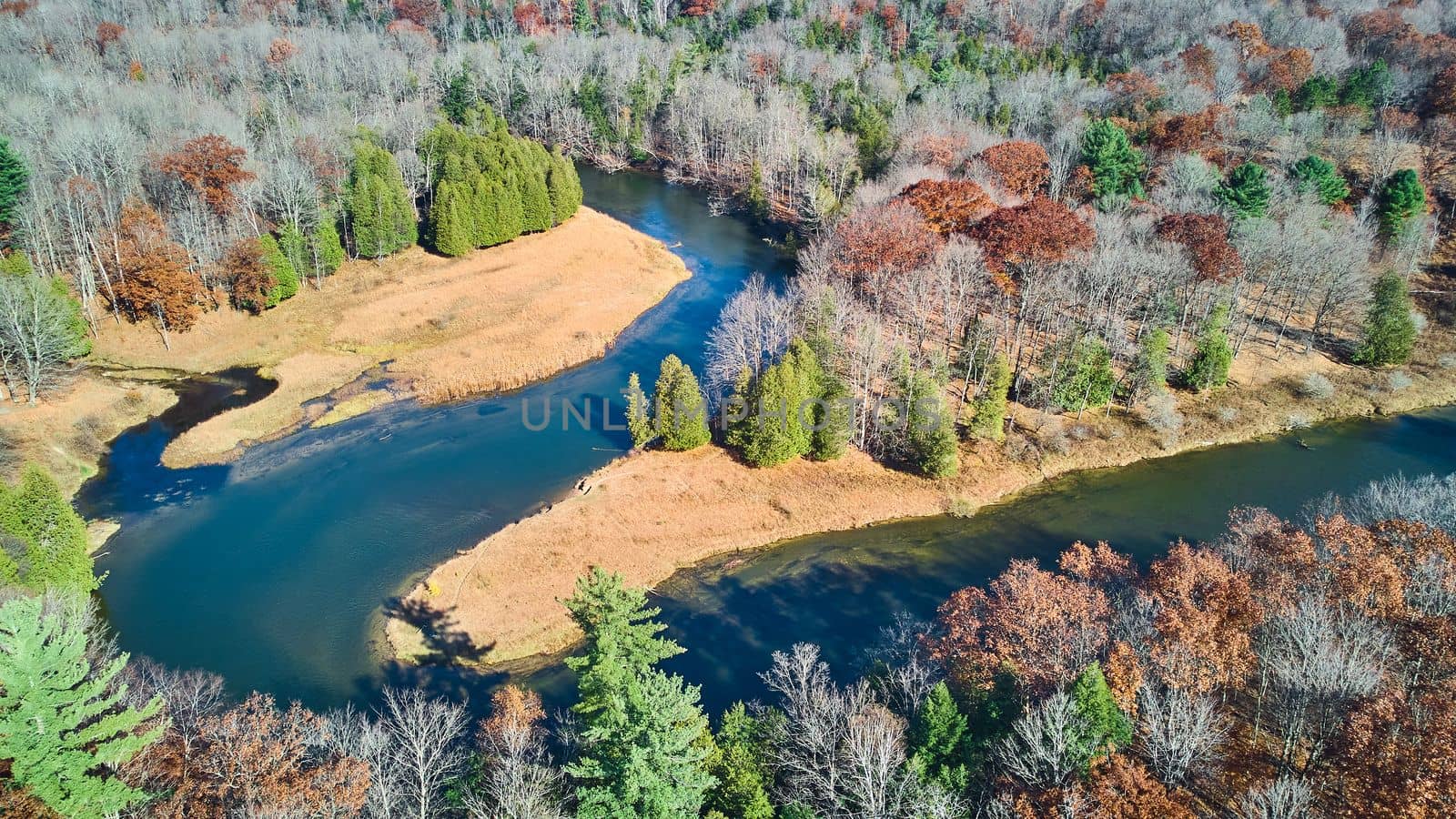Winding river does 180 twist in late fall from aerial view by njproductions