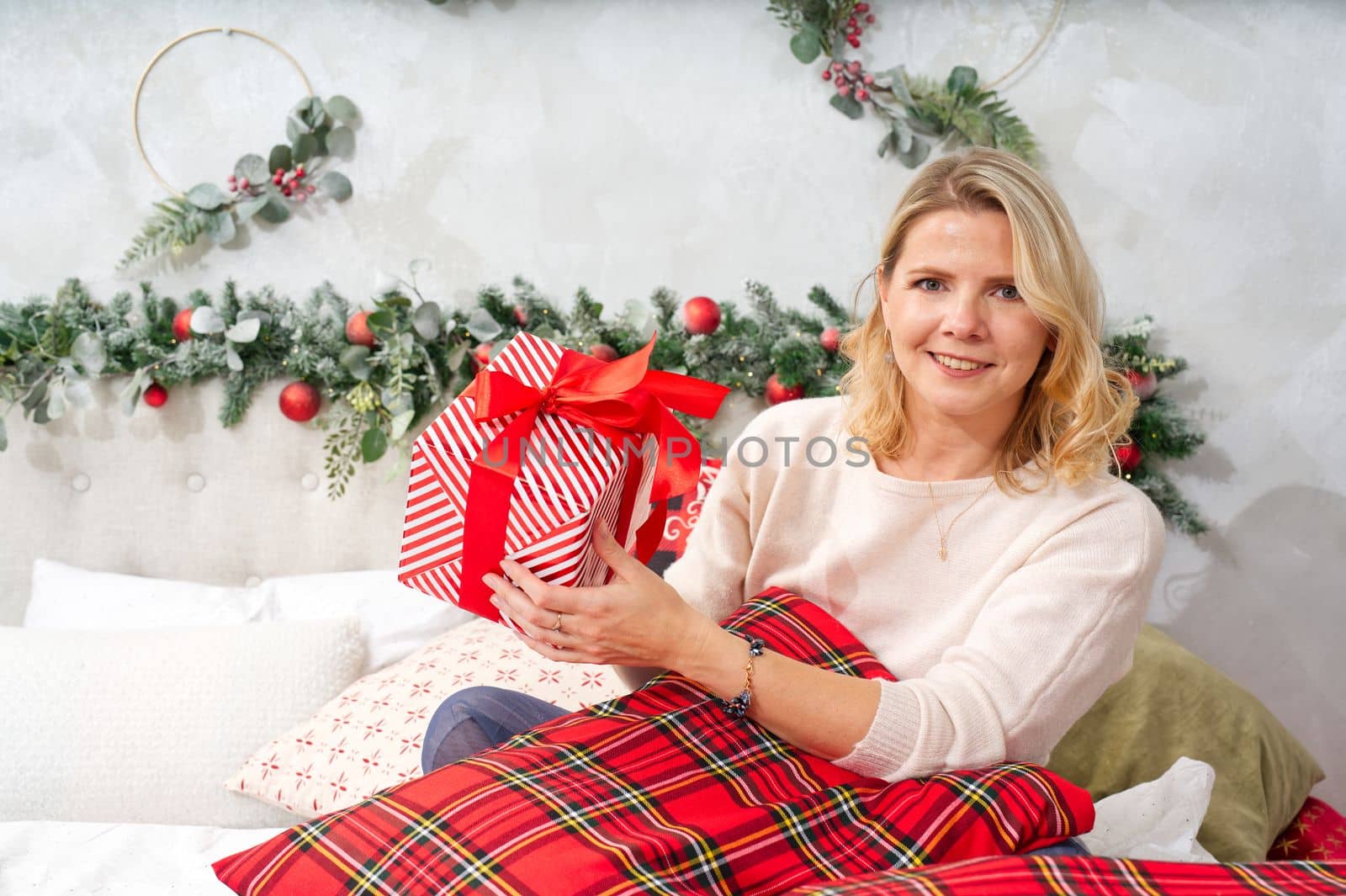Christmas, new year, holidays concept. Happy Woman getting gift box as christmas present. Surprise For You. Excited woman getting unexpected xmas decorated gift box.