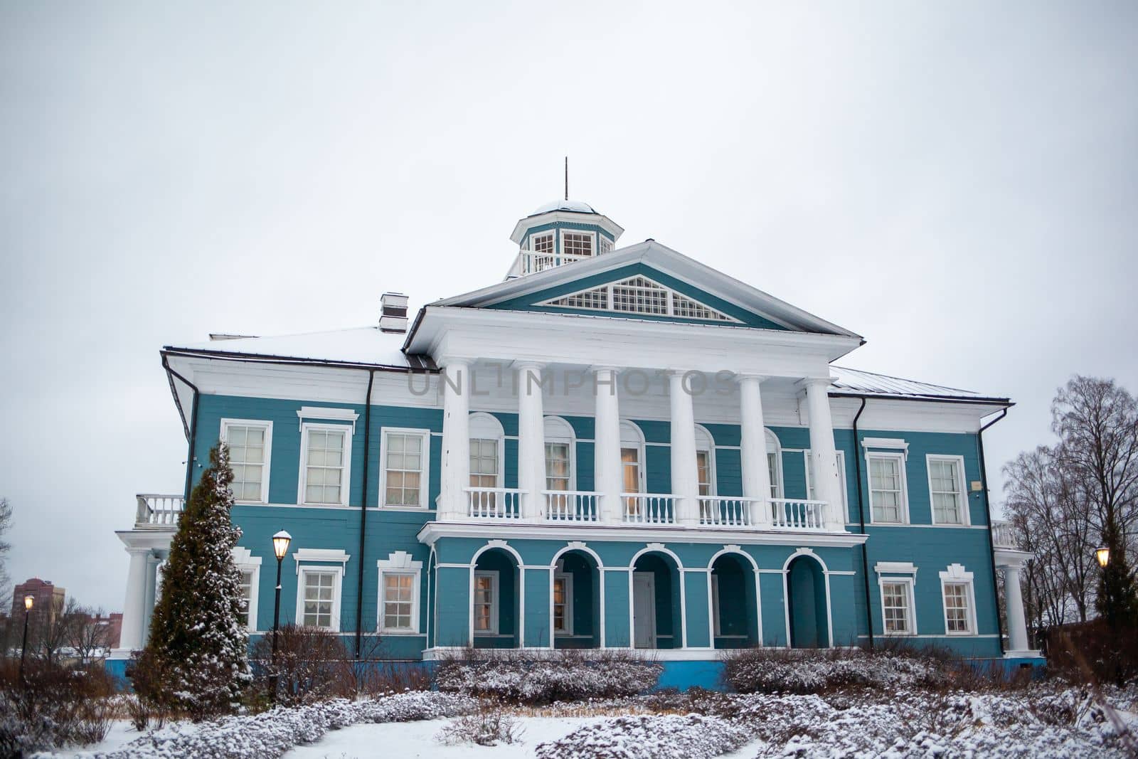 An old beautiful mansion with a wooden veranda, built in the 19th century. A big old house with a garden in Cherepovets, Russia. The building houses a museum 