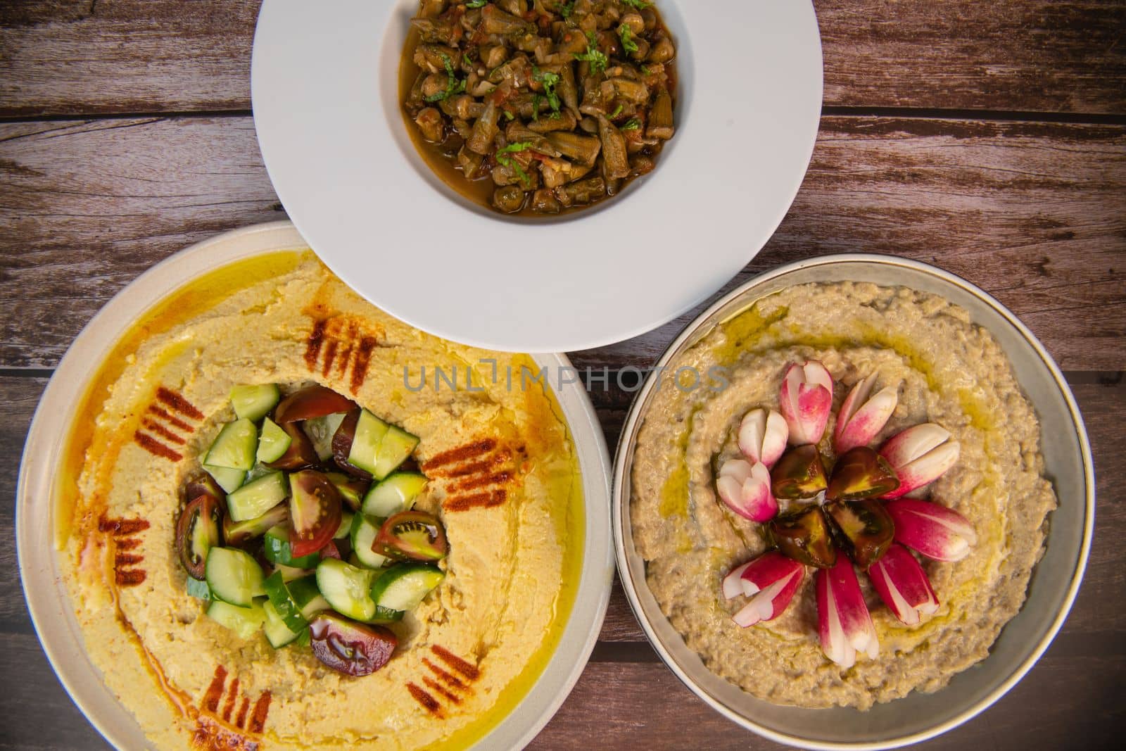 Lebanese meze, hummus, aubergine caviar and okra in tomato sauce. High quality photo