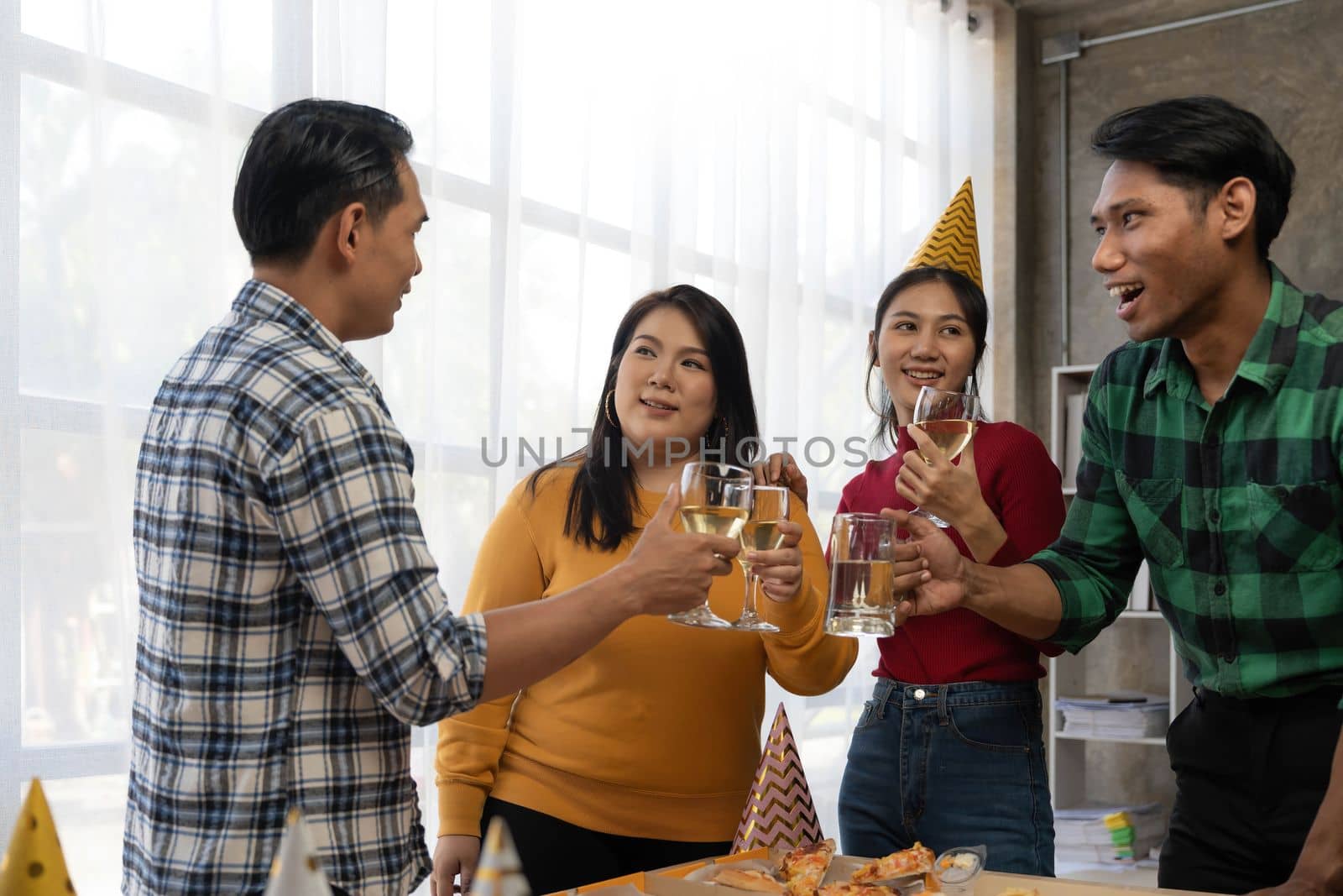 Group of asian friends eating pizza during party at home. Happy asian people having fun together, eating pizza food and beer together with happiness and fun