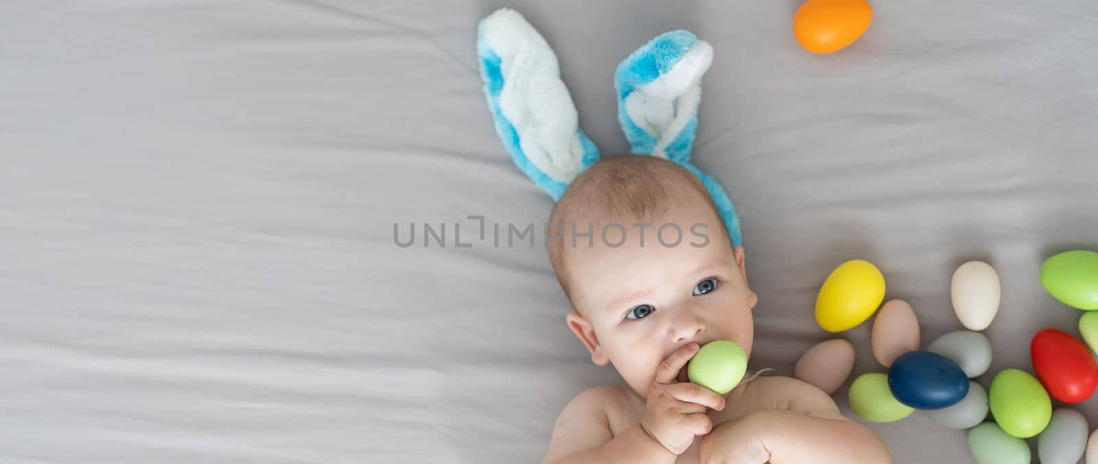 Newborn baby girl in a rabbit ears. Easter Holiday.