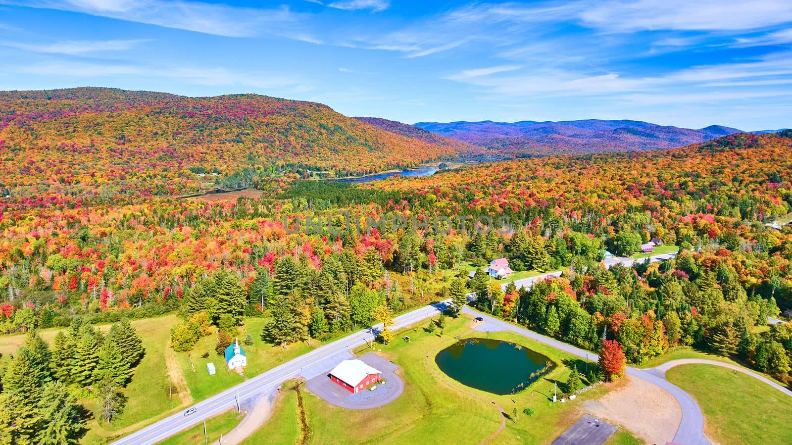 Aerial over road and endless colorful peak fall hills of New York by njproductions