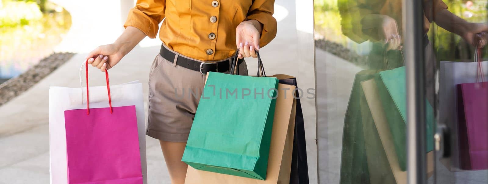 Young woman with face mask shopping during virus pandemic.