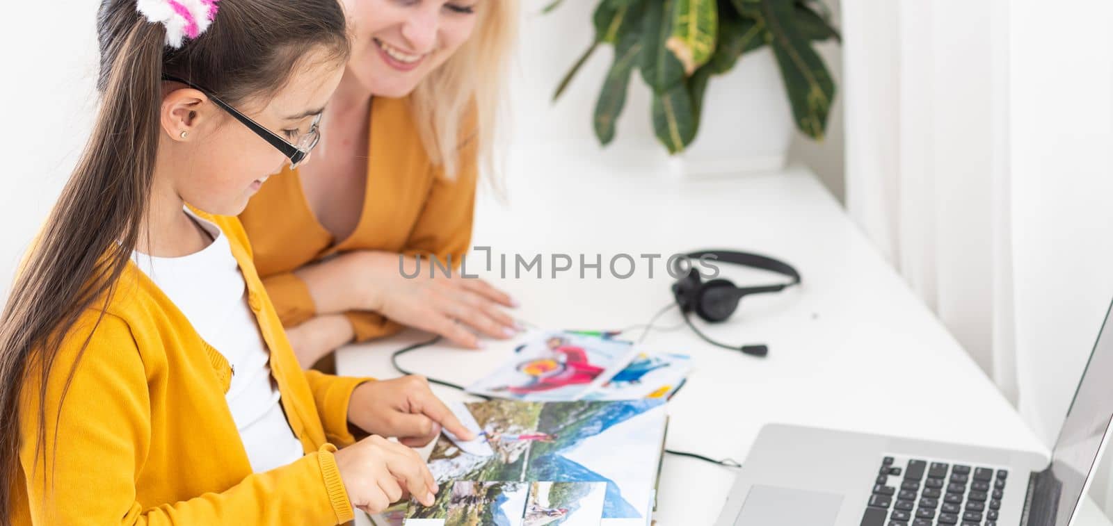 Little girl looking her family photo in album.
