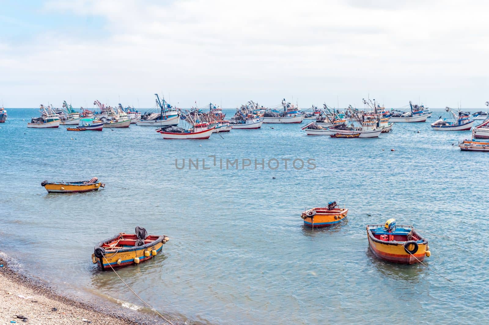fishing boats in the ocean at the shore of the village. 