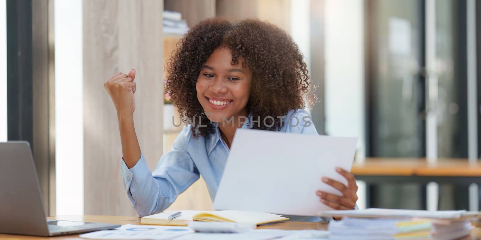 Black businesswoman work on laptop feel euphoric winning. Excited female triumph get good news from work.