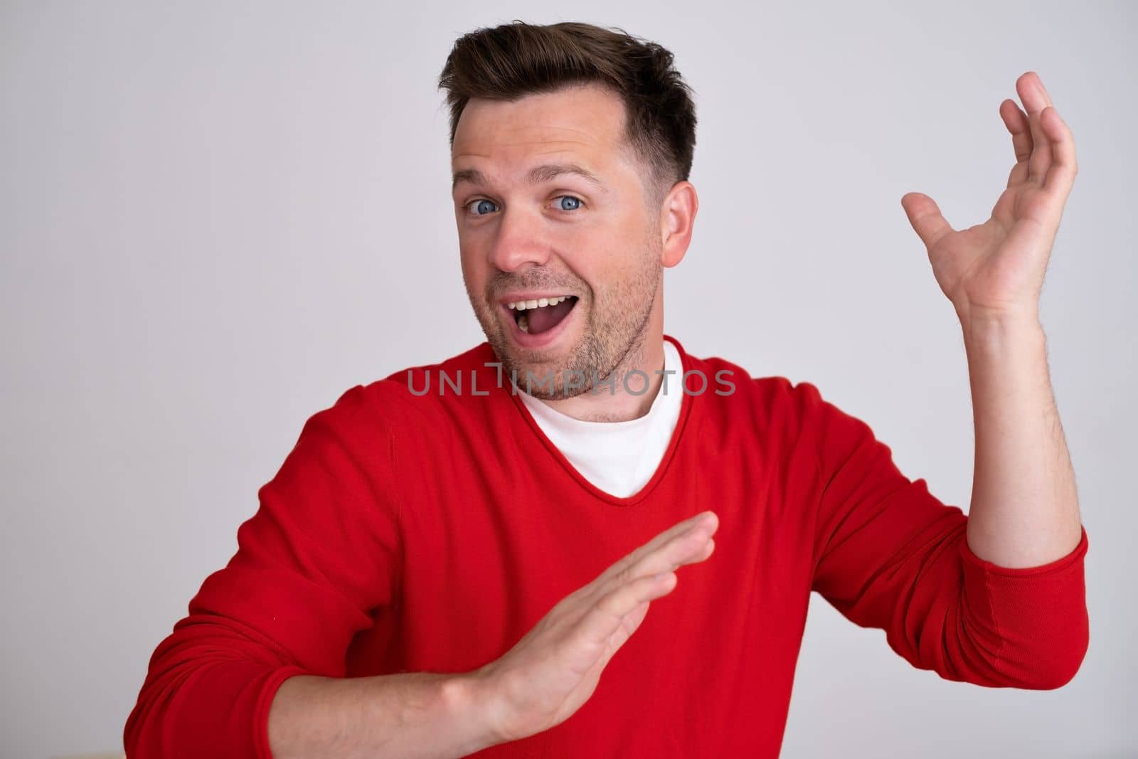 young man smiling, feeling carefree, relaxed and happy, dancing