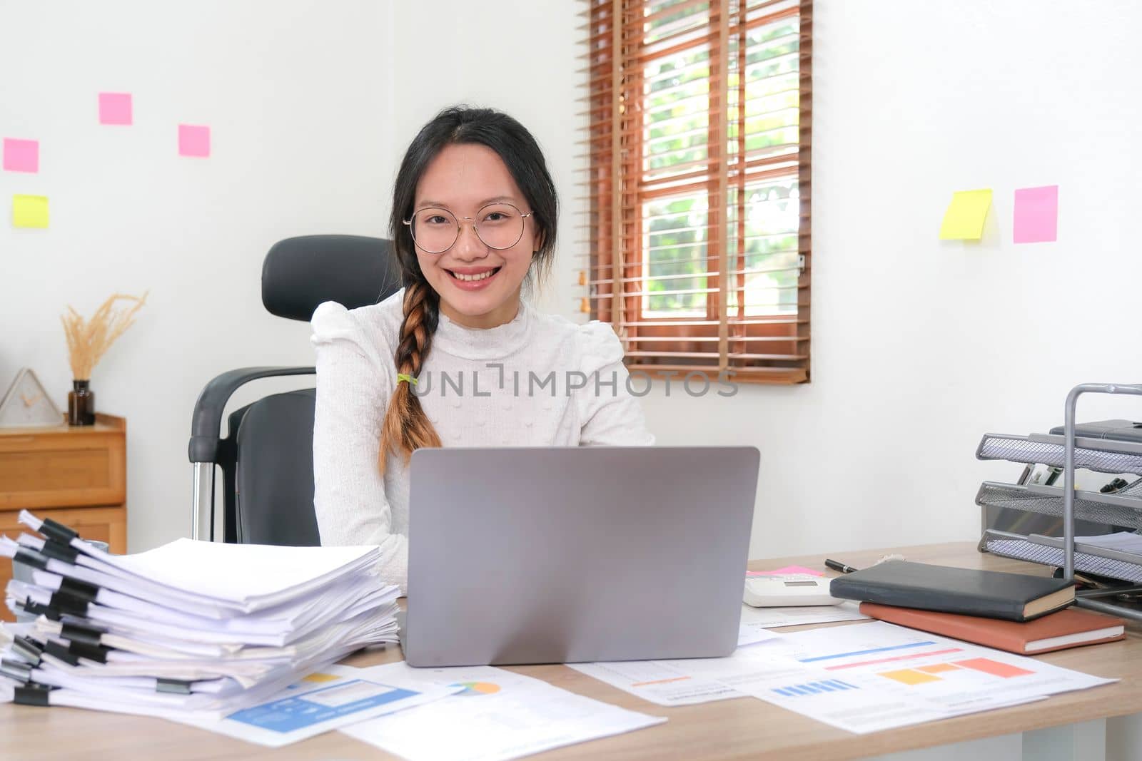 Cheerful lady working on laptop in home and use a computer laptop and thinking idea for her business..