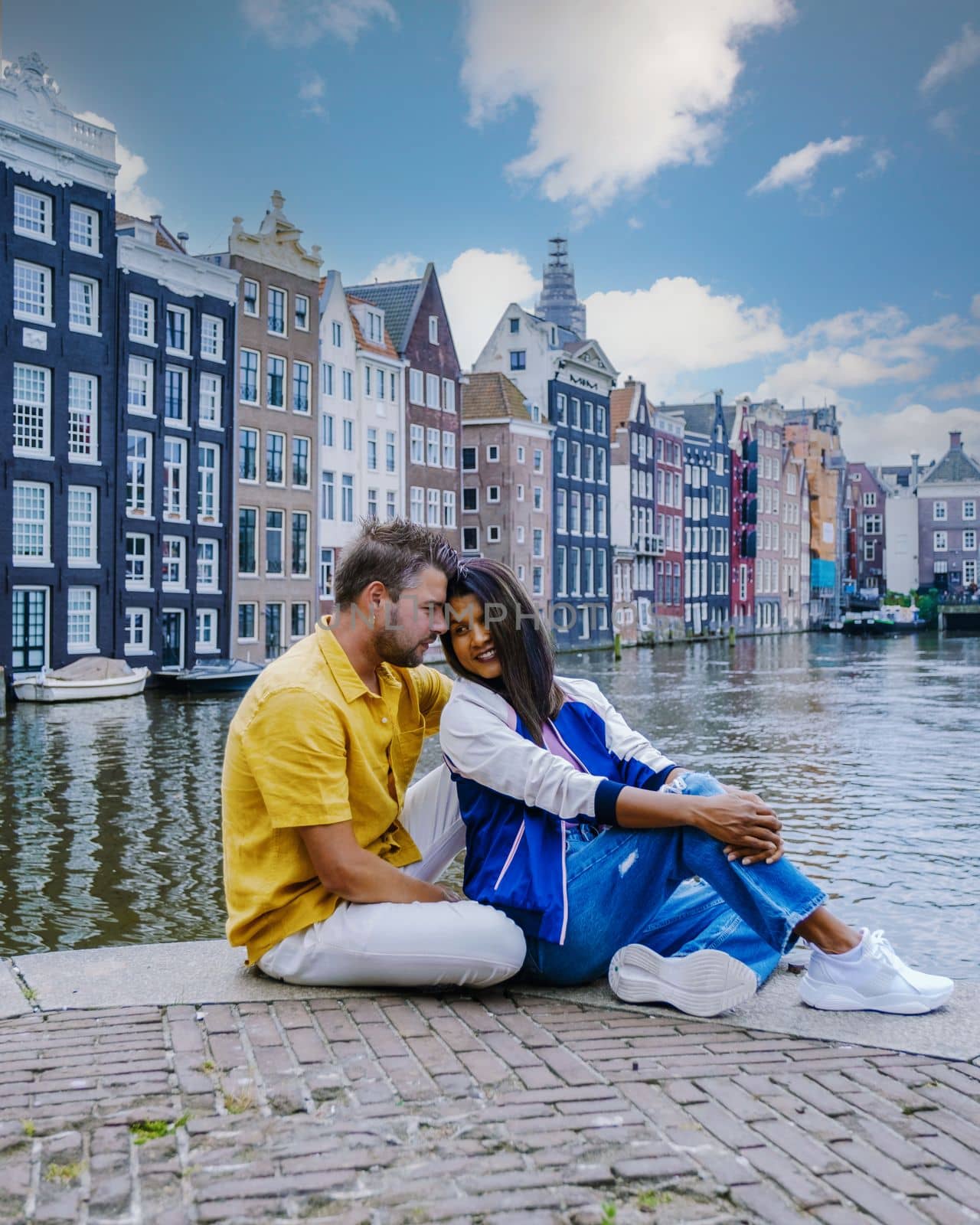 Amsterdam Netherlands, happy couple man and woman on a summer evening at the canals of Amsterdam by fokkebok