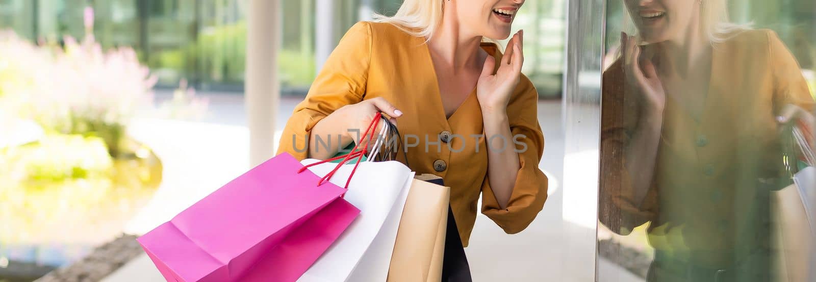 Positive emotions. Lifestyle concept. Close up of young charming caucasian woman smiling with teeth, looking aside with relaxed expression.