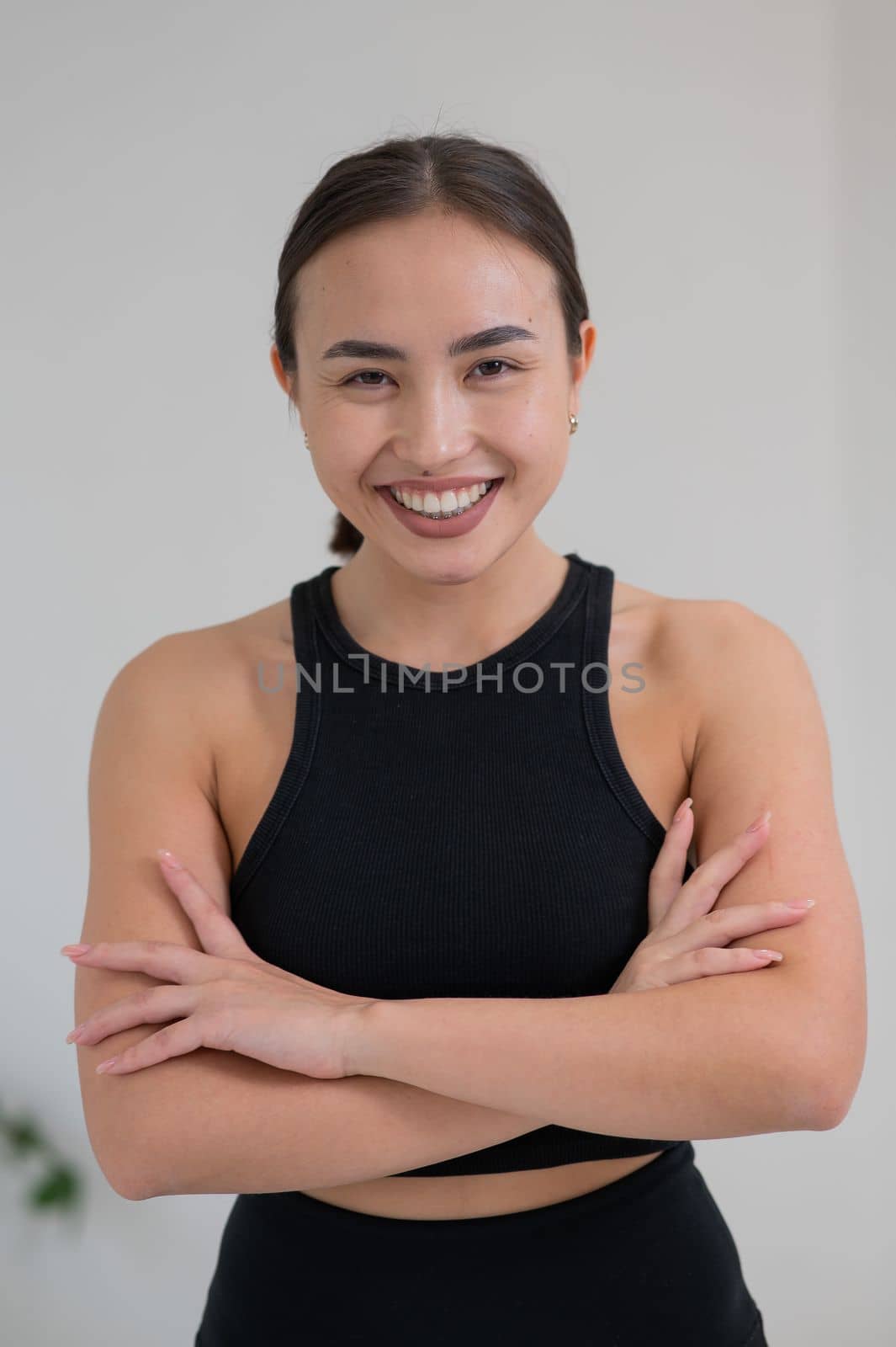 Portrait of a beautiful Asian woman with crossed arms on her chest