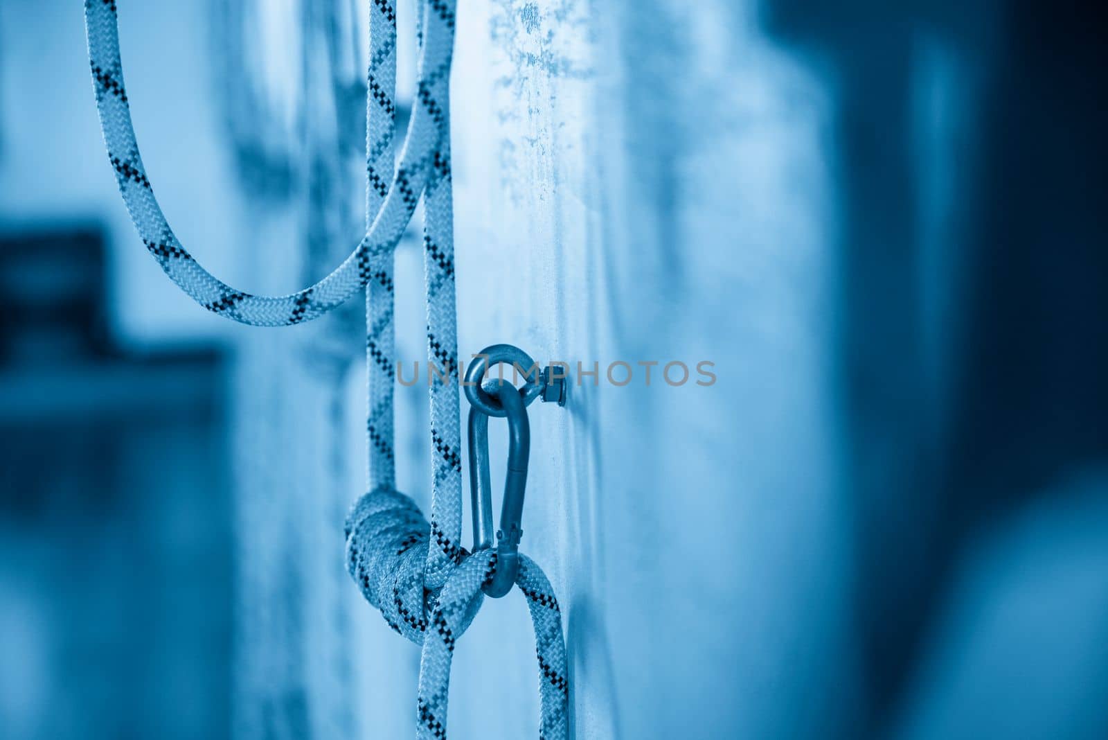 Yoga ropes hanging on empty studio wall. Iyengar yoga by Mariakray