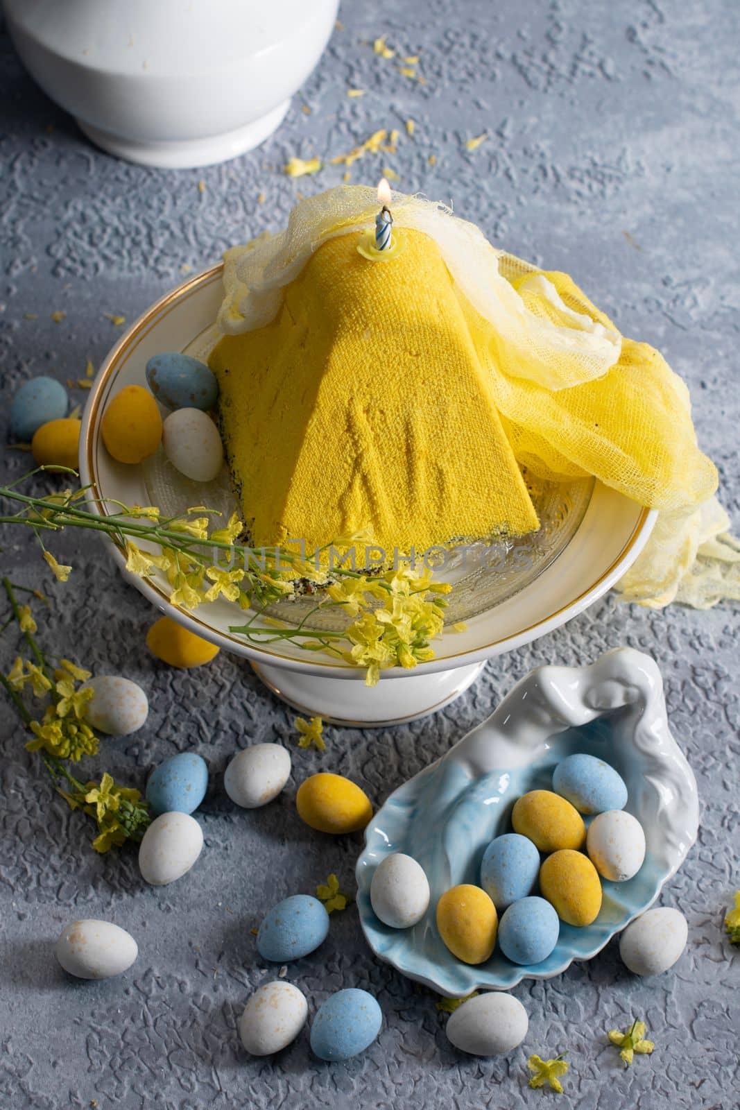 Traditional Easter Orthodox curd cake with yellow flowers on a grey table, High quality photo