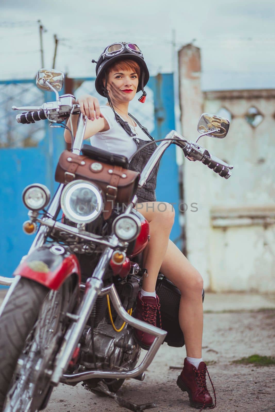 Beautiful slim woman smiling on a motorcycle.