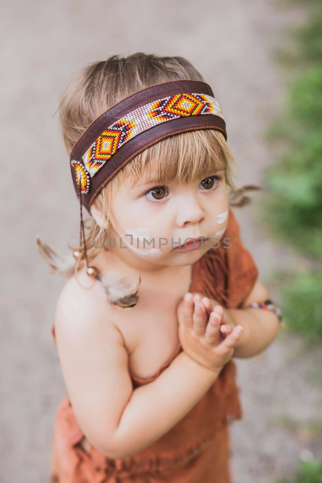 Cute baby dressed in traditional native americanс costume