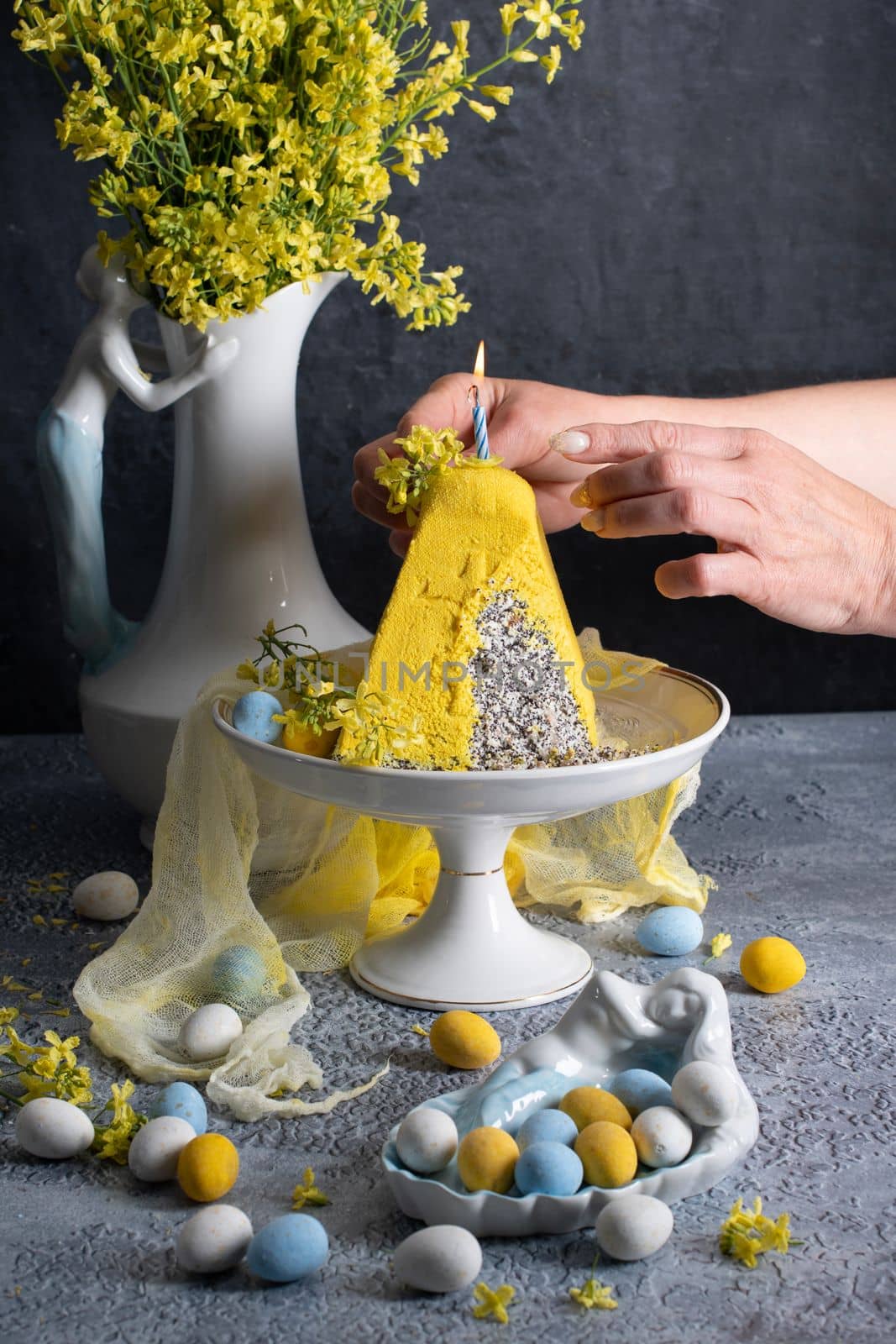 Traditional Easter Orthodox curd cake with yellow flowers on a grey table, High quality photo