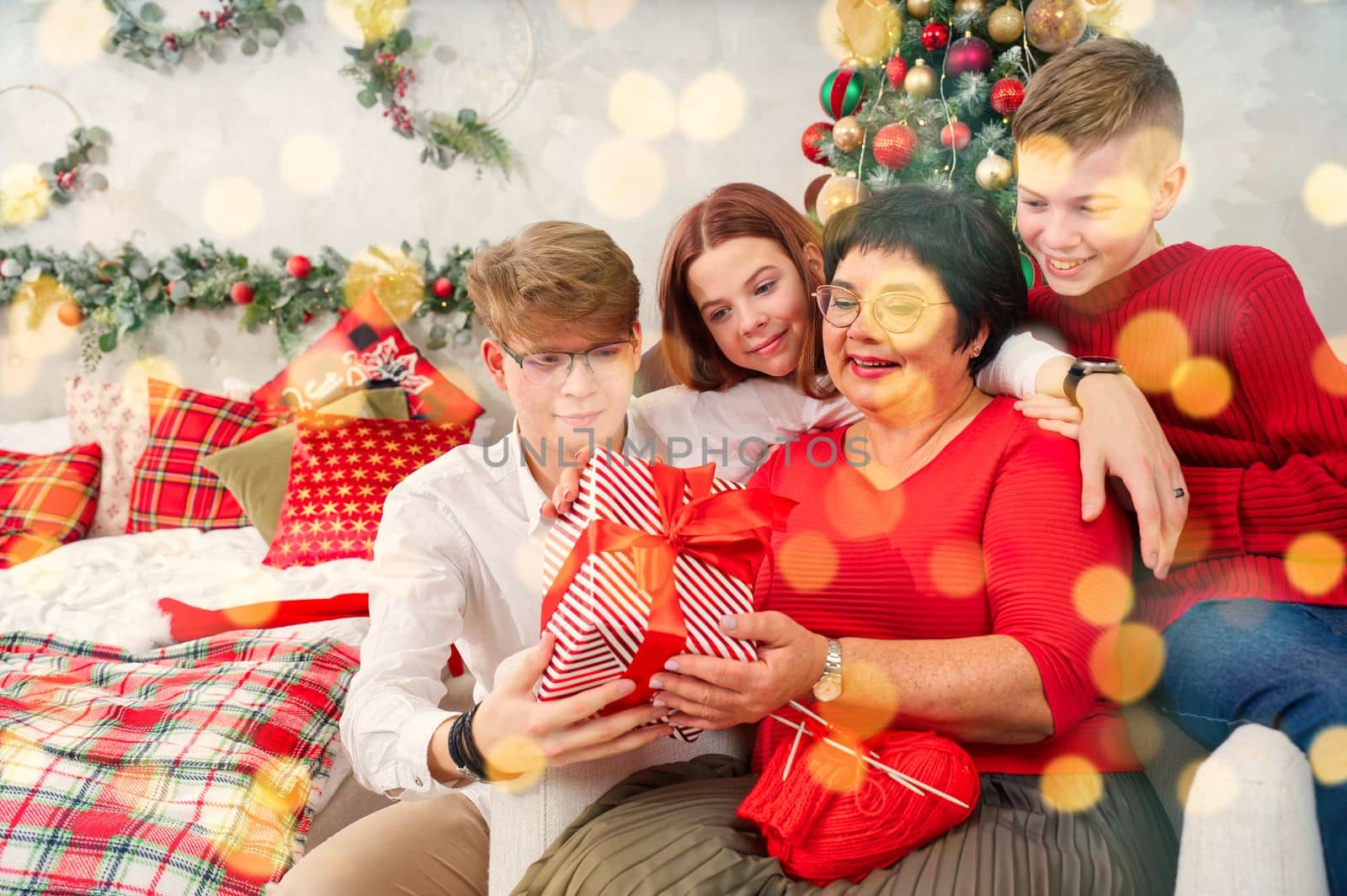 Mother with three children unpacks a christmas gift. Christmas wonder. christmas holiday