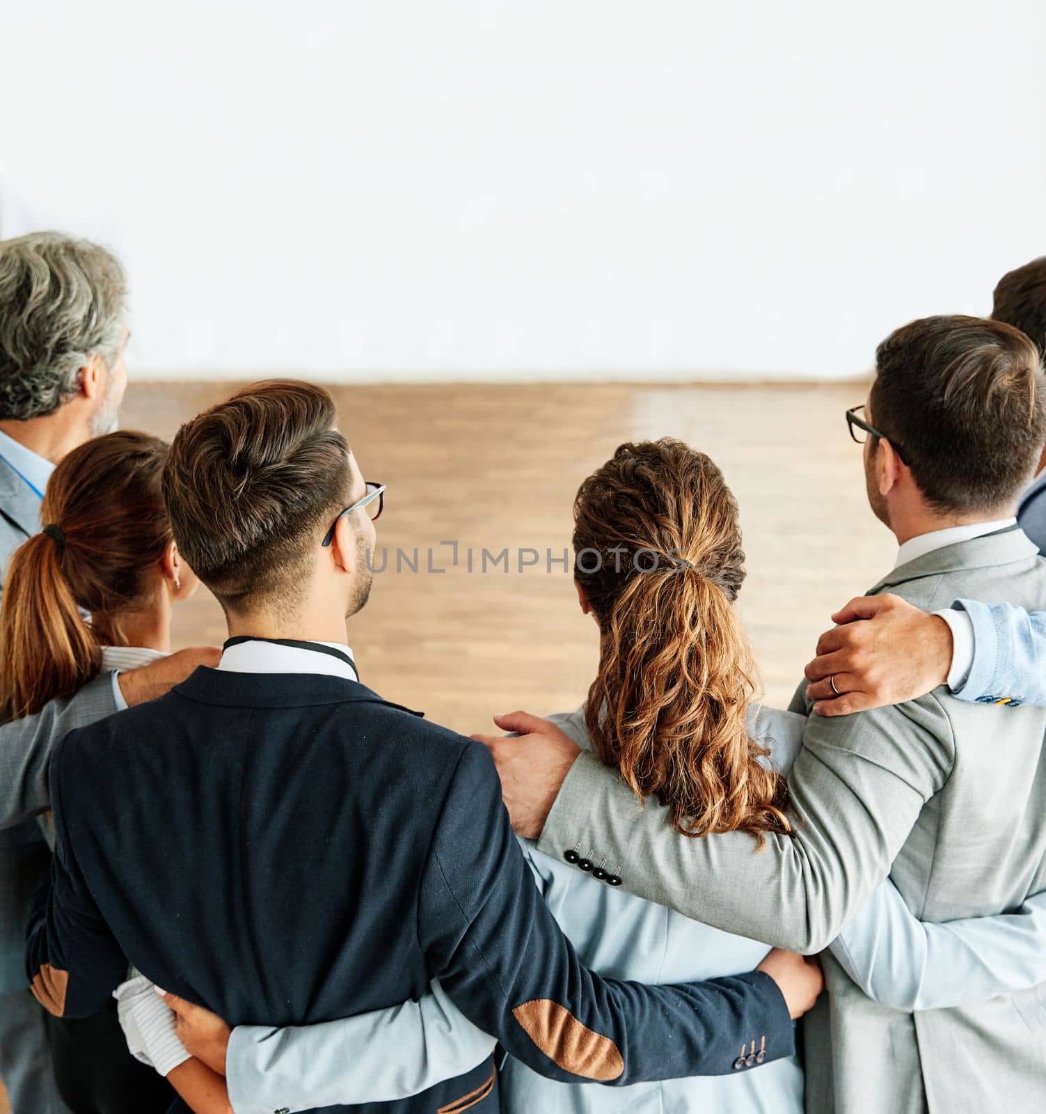 business teamwork together support group colleague businessman businesswoman team office strong colleague holding hug by Picsfive