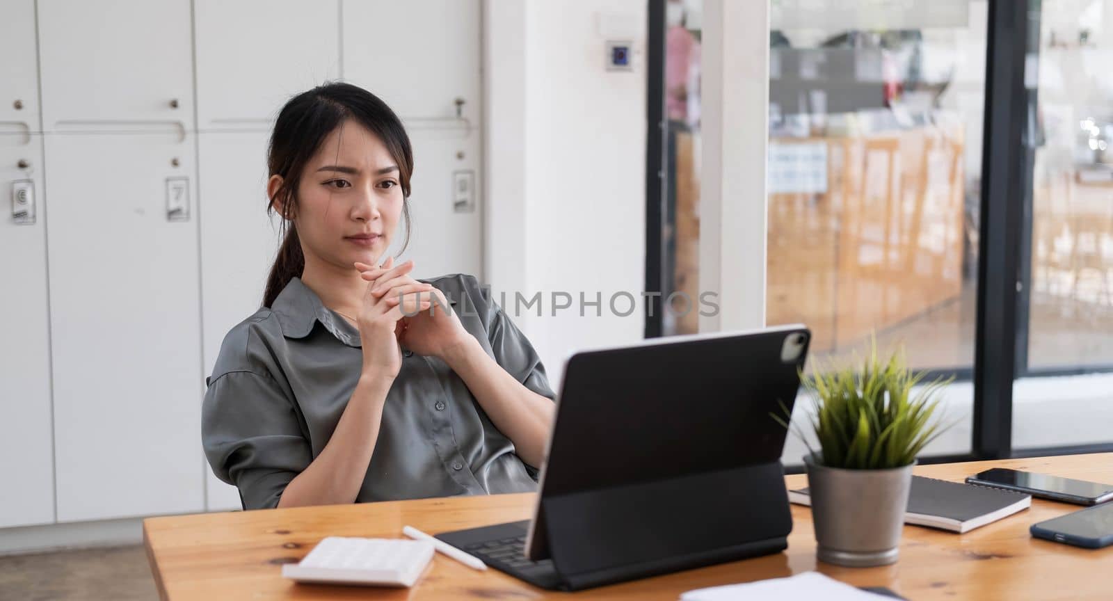 Asian businesswoman are serious at work causing headache stressed out with documents with a laptop at the office...