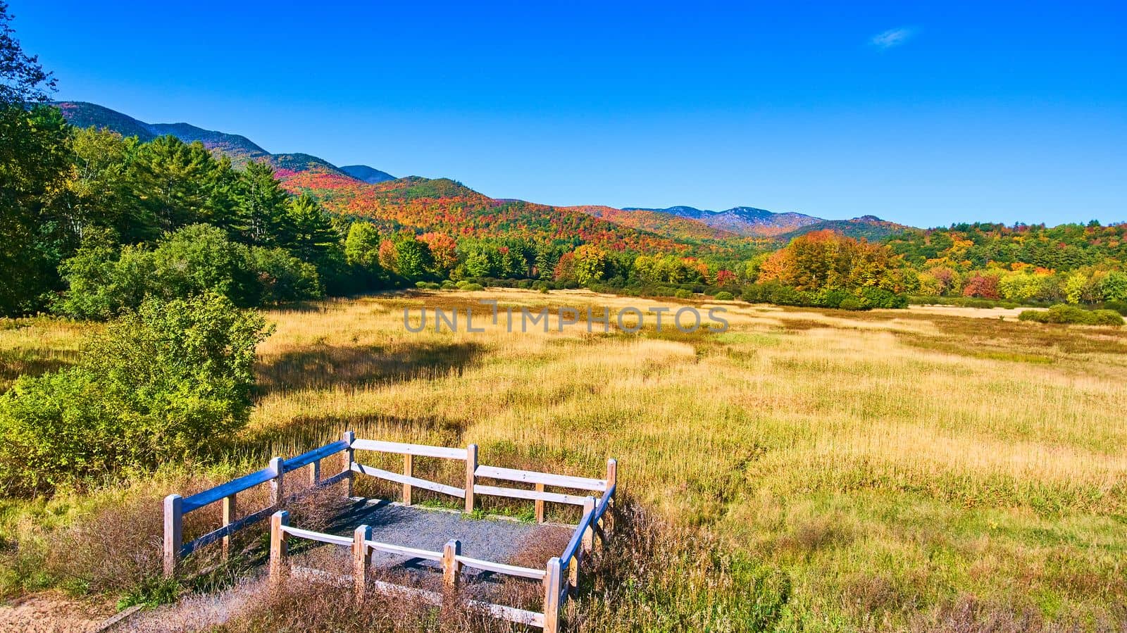 View stunning fields and colorful mountains from small fenced platform by njproductions