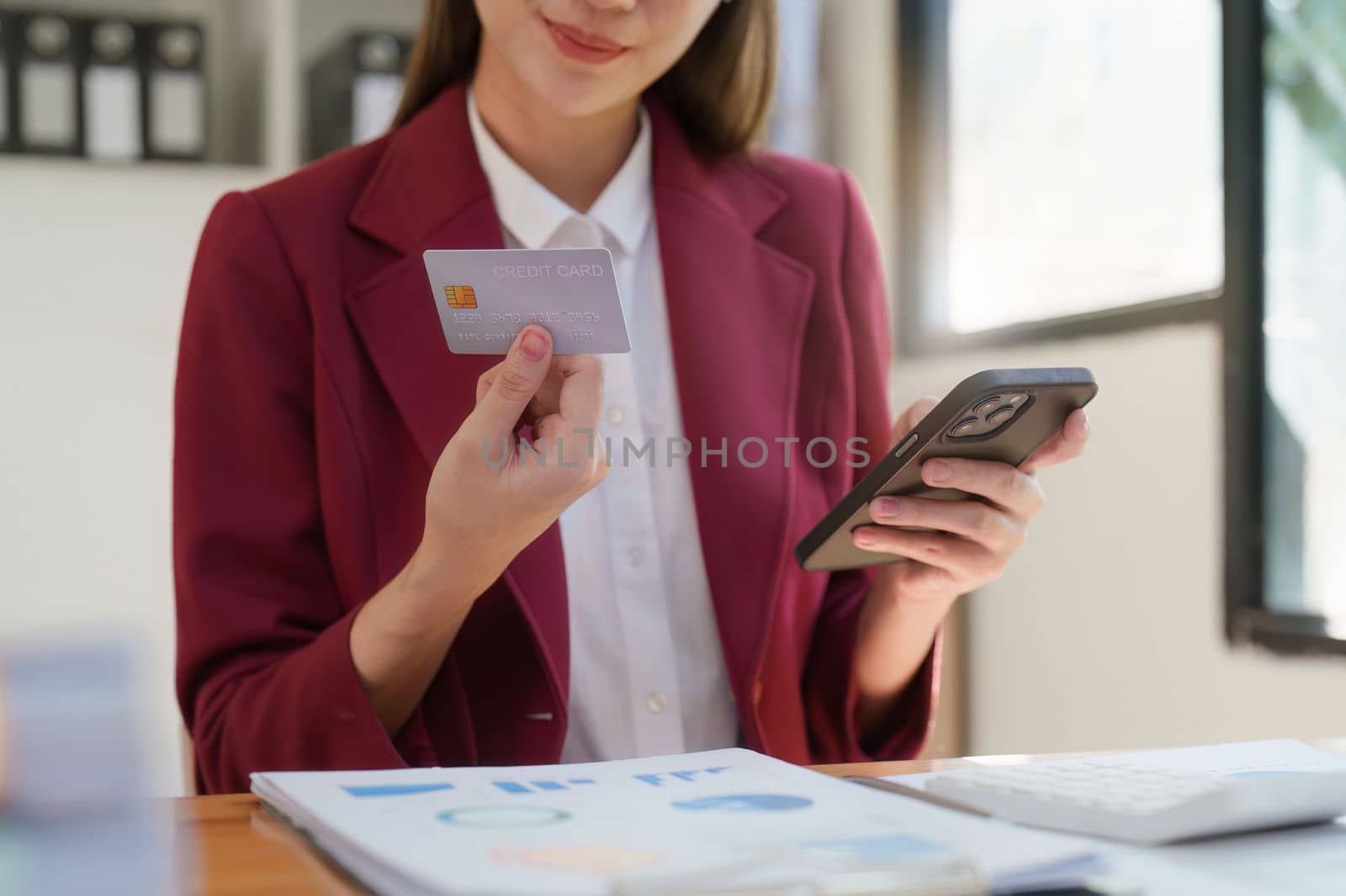 Asian woman using smartphone and credit card for online shopping. E-payment technology, shopaholic lifestyle, mobile phone financial application concep by itchaznong