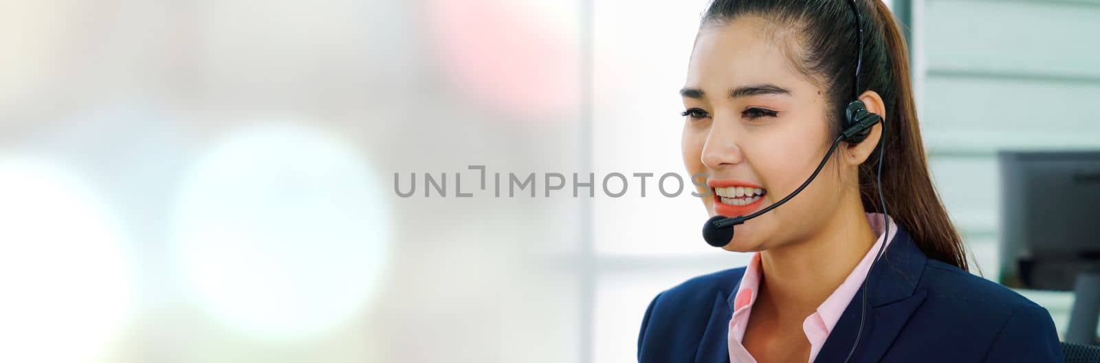 Business people wearing headset working in office in widen view to support remote customer or colleague. Call center, telemarketing, customer support agent provide service on telephone video call.