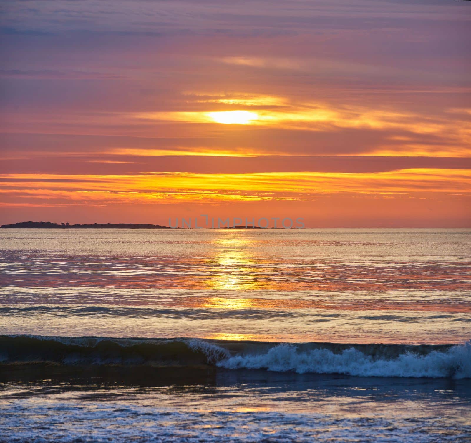 Image of Stunning sunrise over east coast ocean with crashing waves